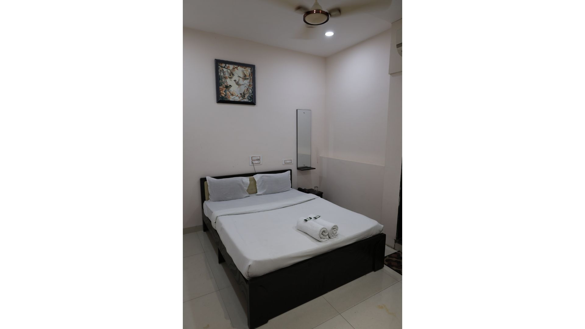 black and white bed near brown wooden table