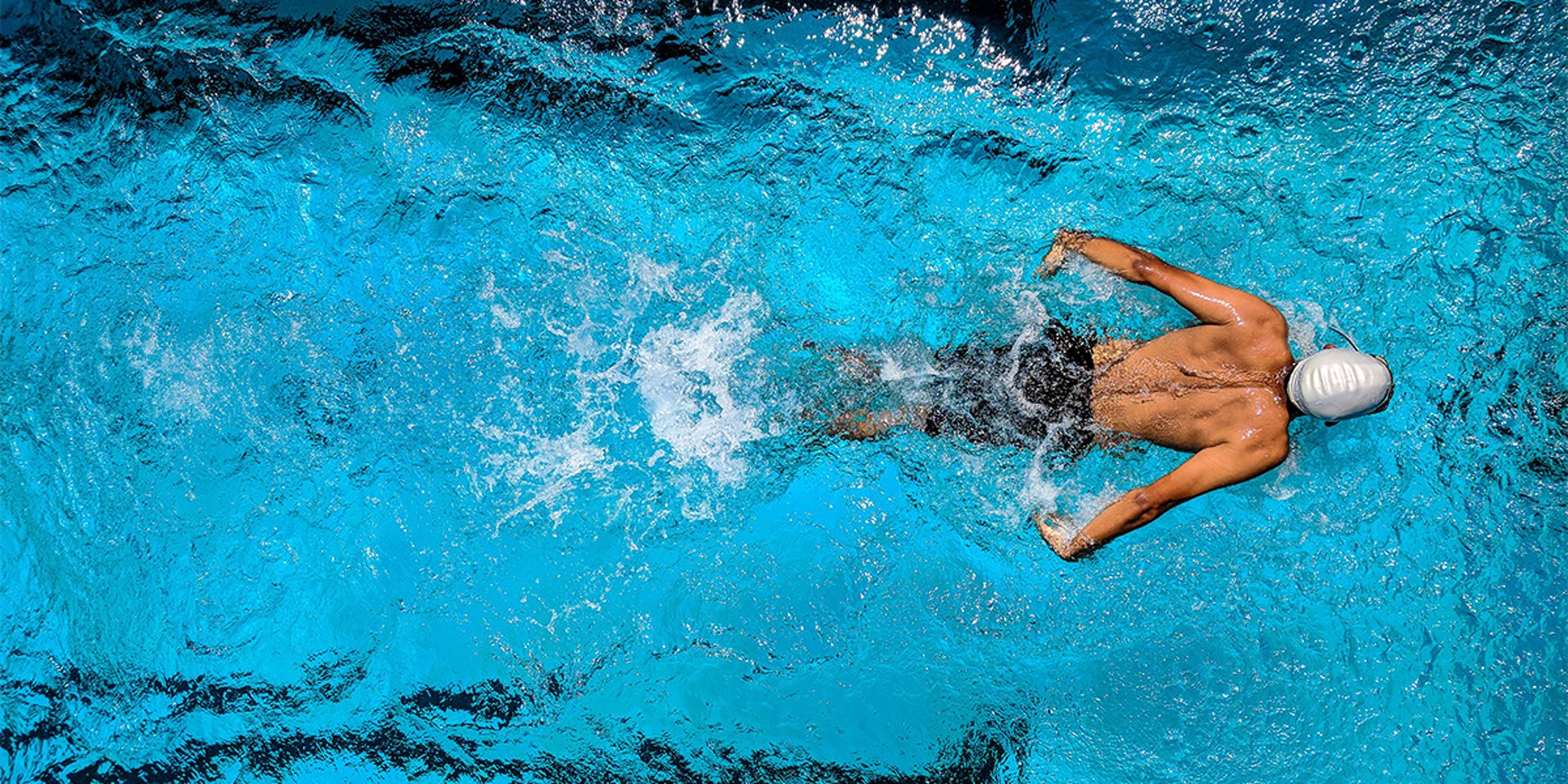 three men swimming in swimming pool