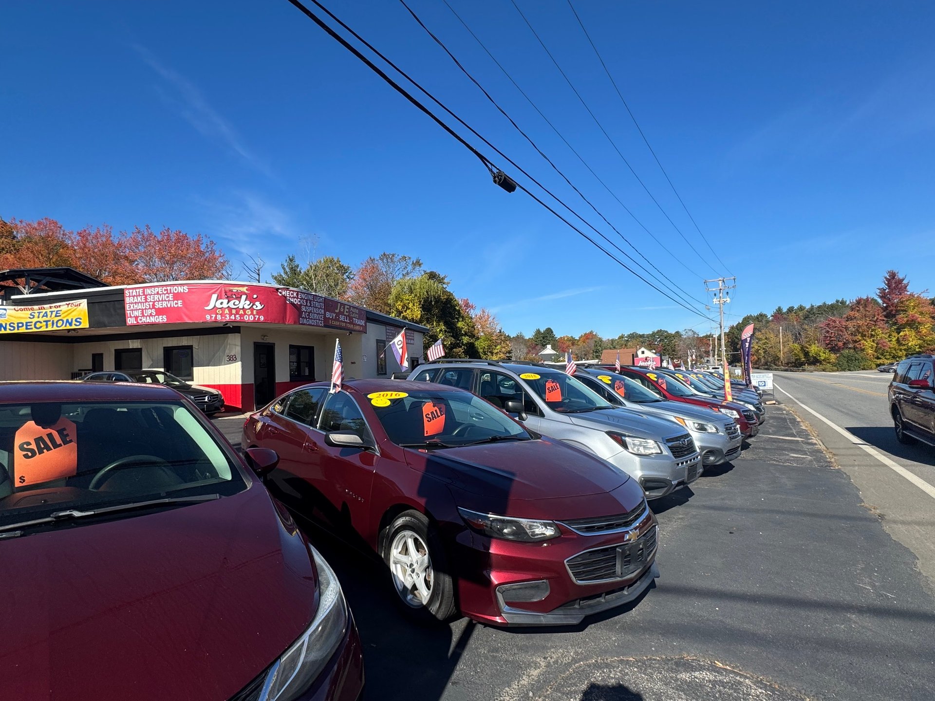 Three BMW cars are parked in front of a building.