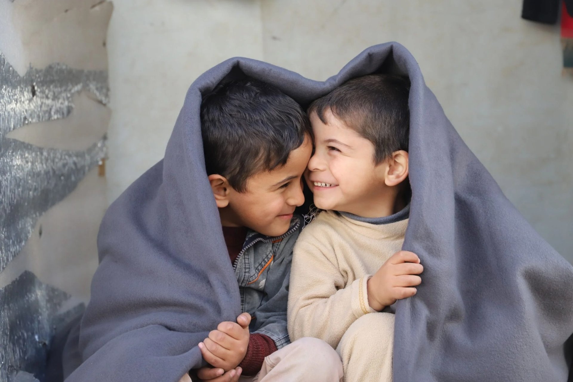 2 boys standing near wooden door