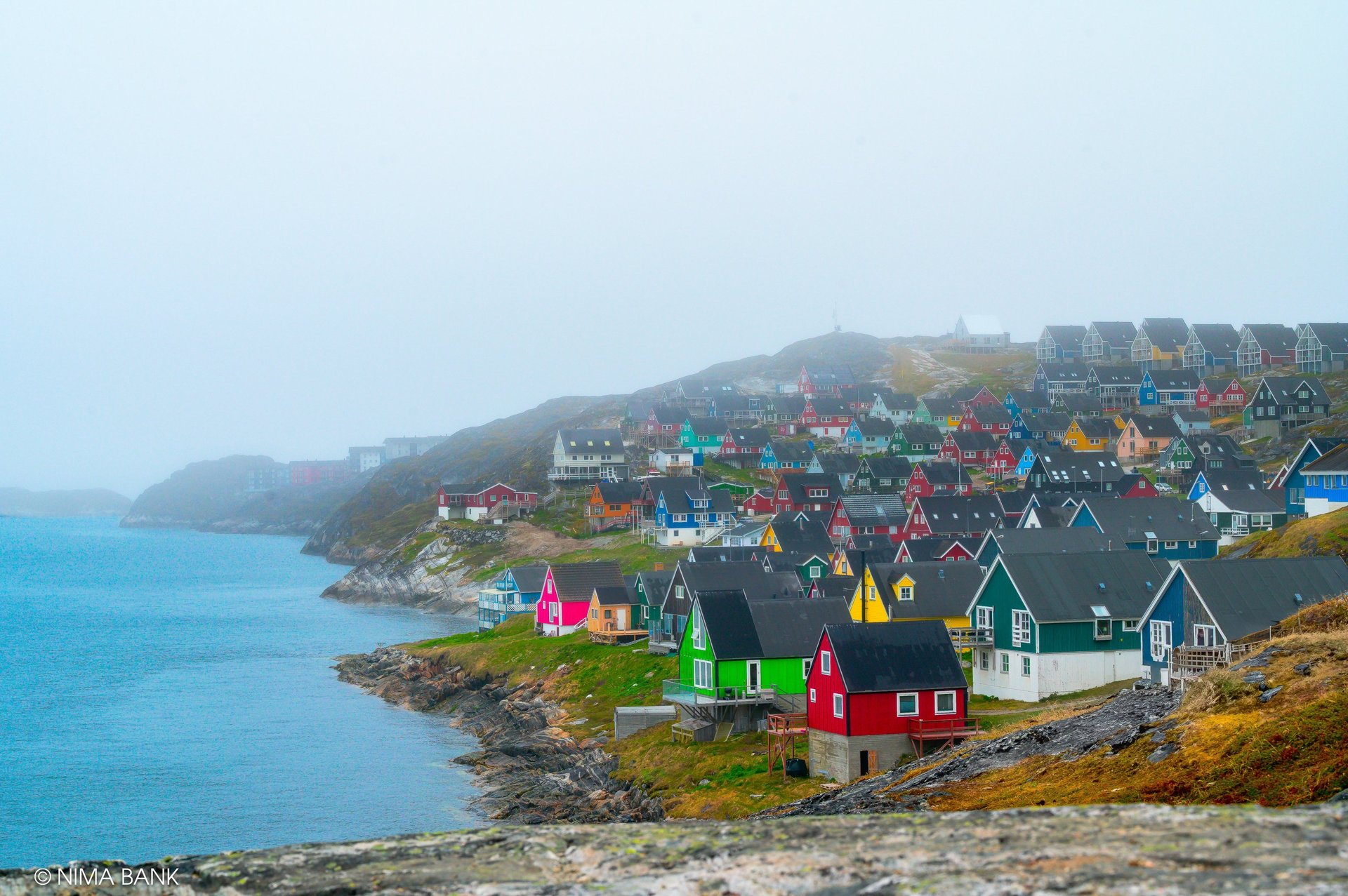 an abstract photo of a curved building with a blue sky in the background
