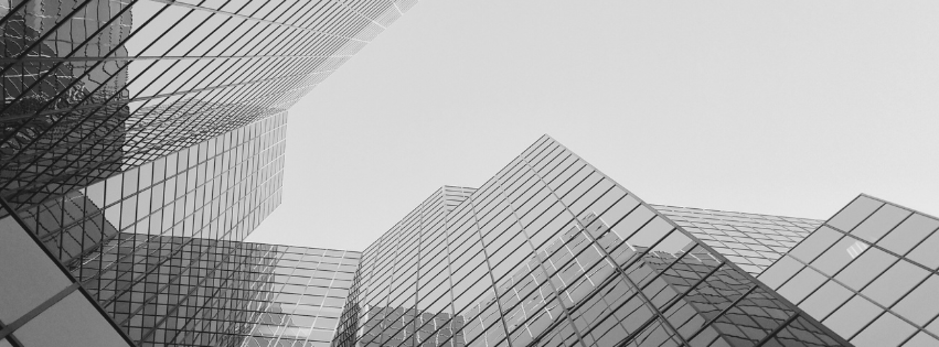 an abstract photo of a curved building with a blue sky in the background