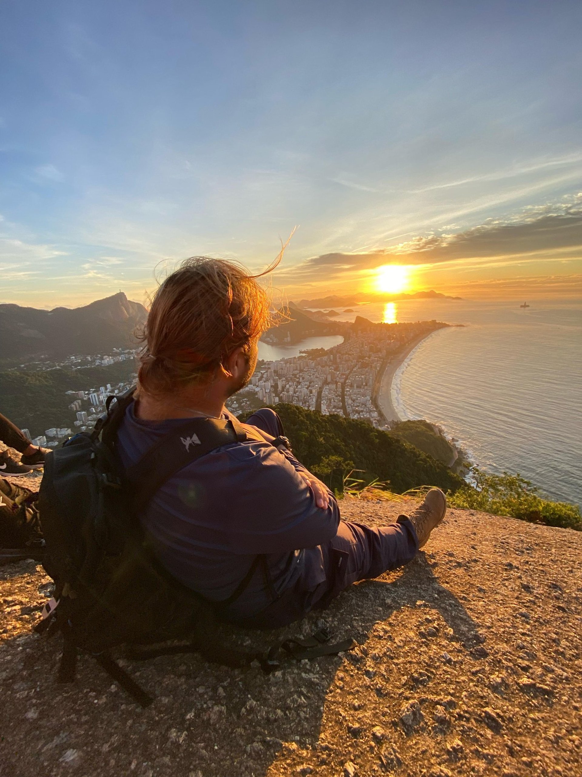 a couple of people standing on top of a mountain