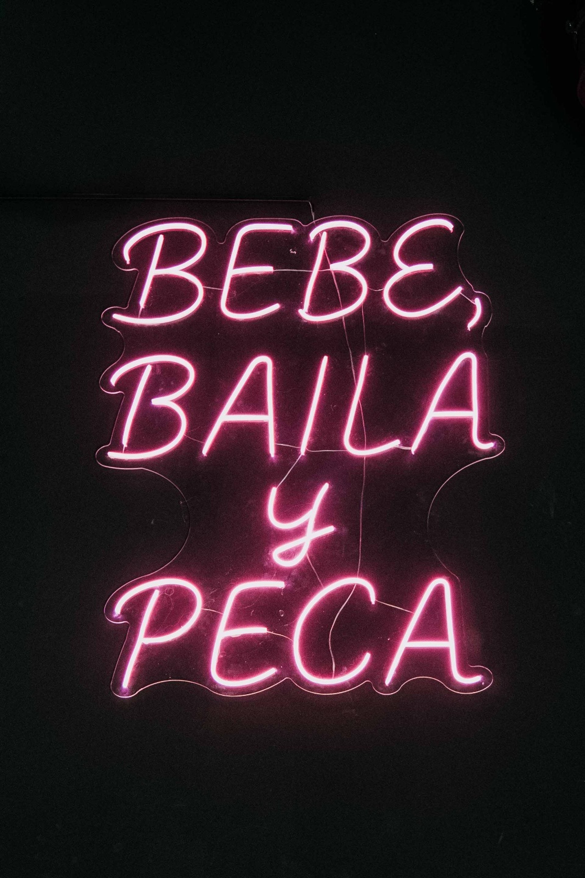 an abstract photo of a curved building with a blue sky in the background