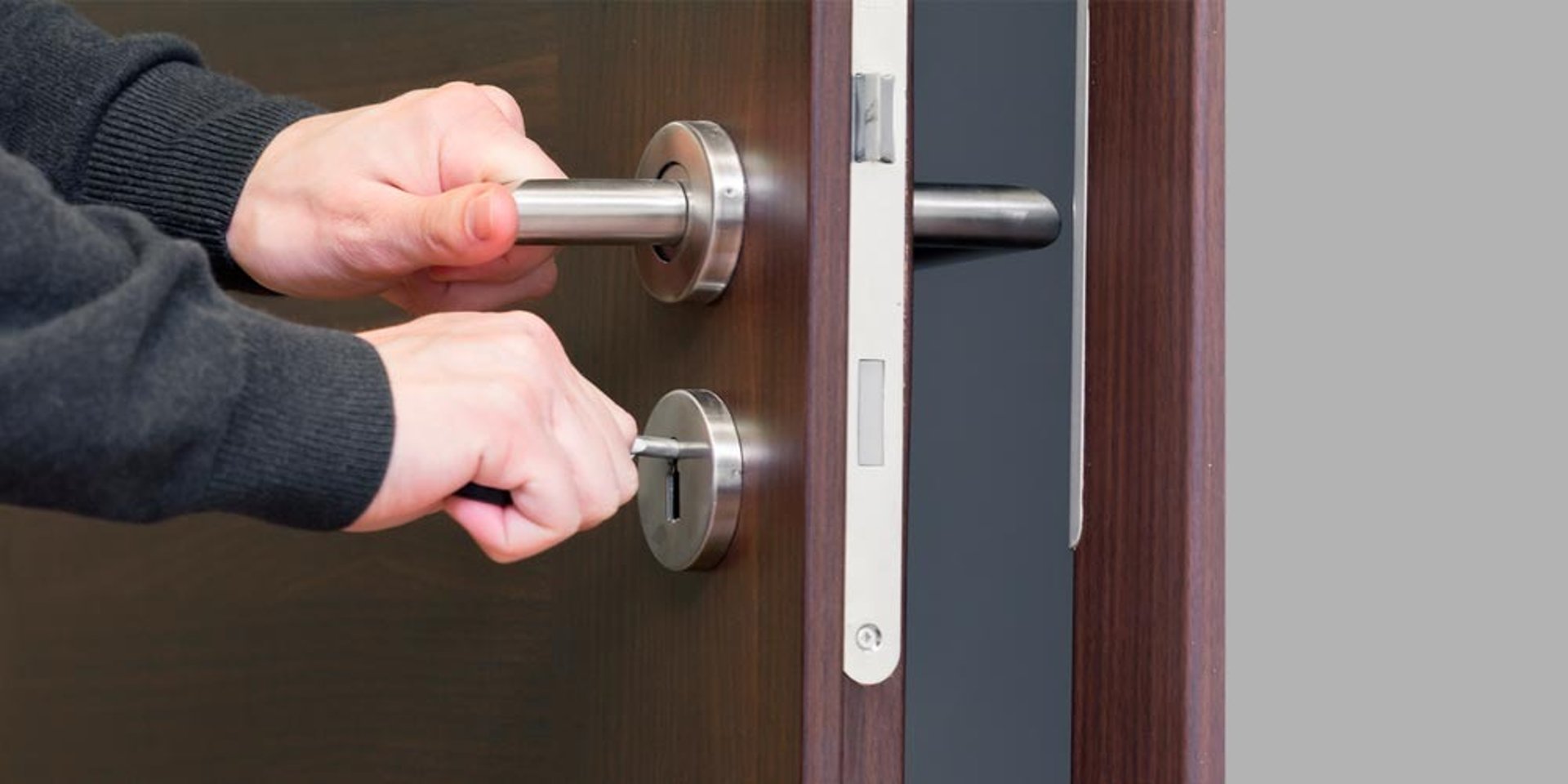 person holds door lever