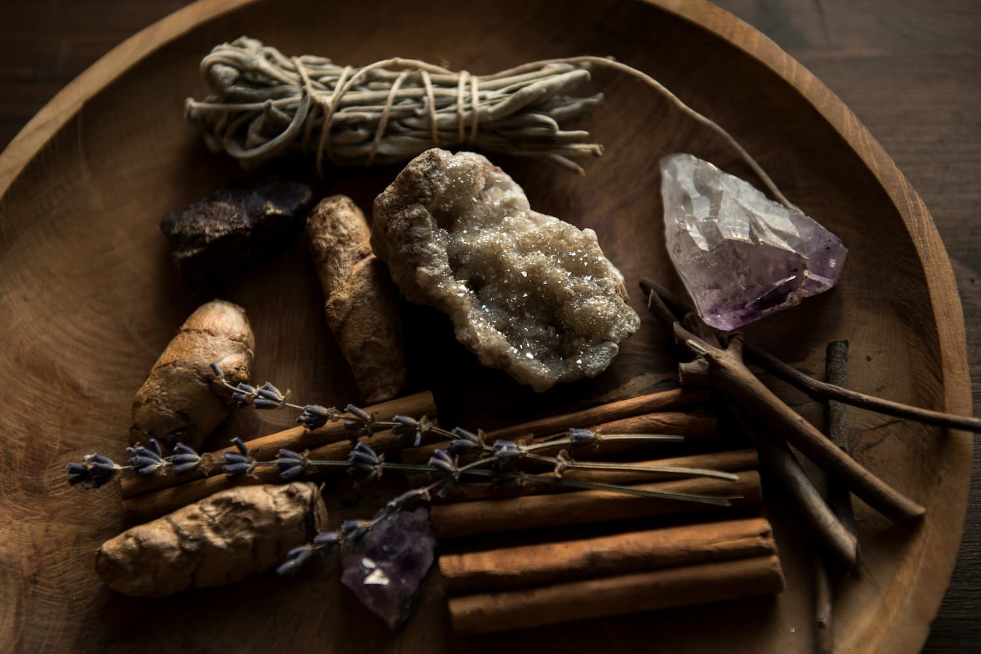 Energy cleansing tools with crystals, sage, cinnamon, and lavender on a wooden tray – psychic blog image.
