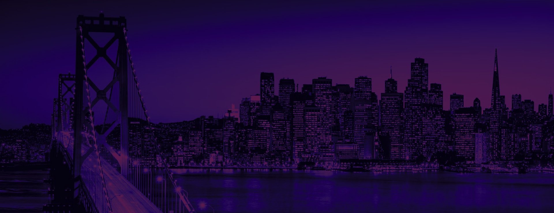 a view of a city at night from the top of a hill