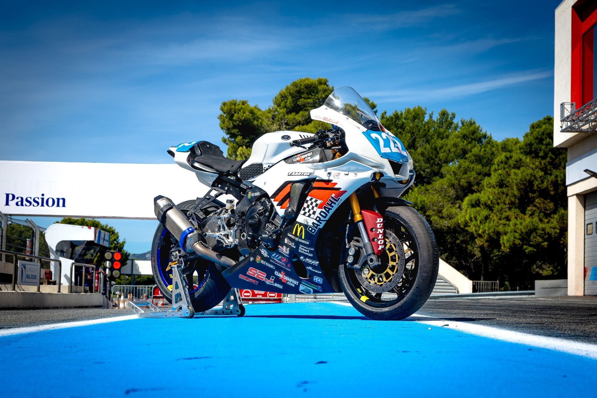 an abstract photo of a curved building with a blue sky in the background