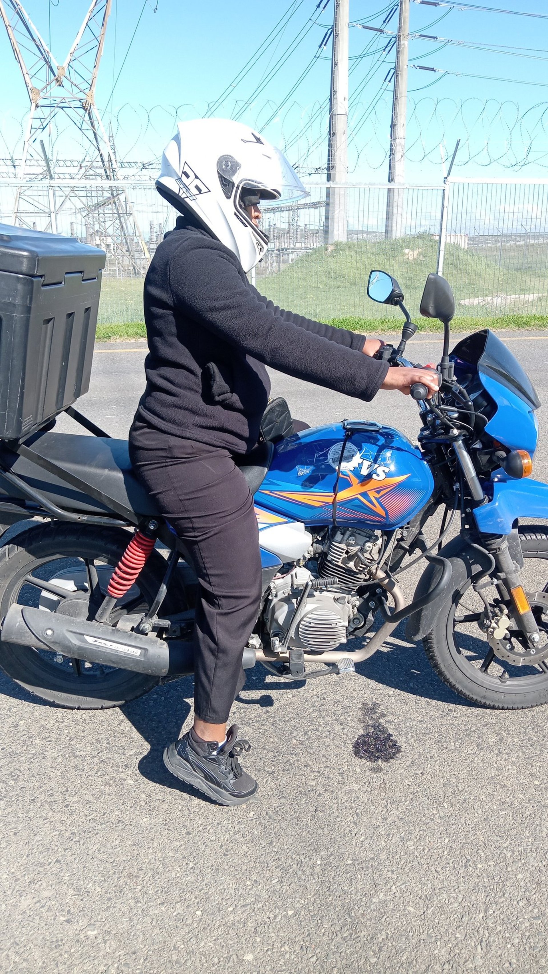 A man riding a motorcycle down a dirt road