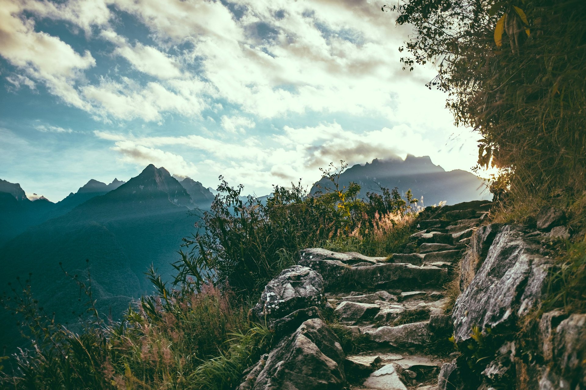 rocky path with mountain view on cloudy day