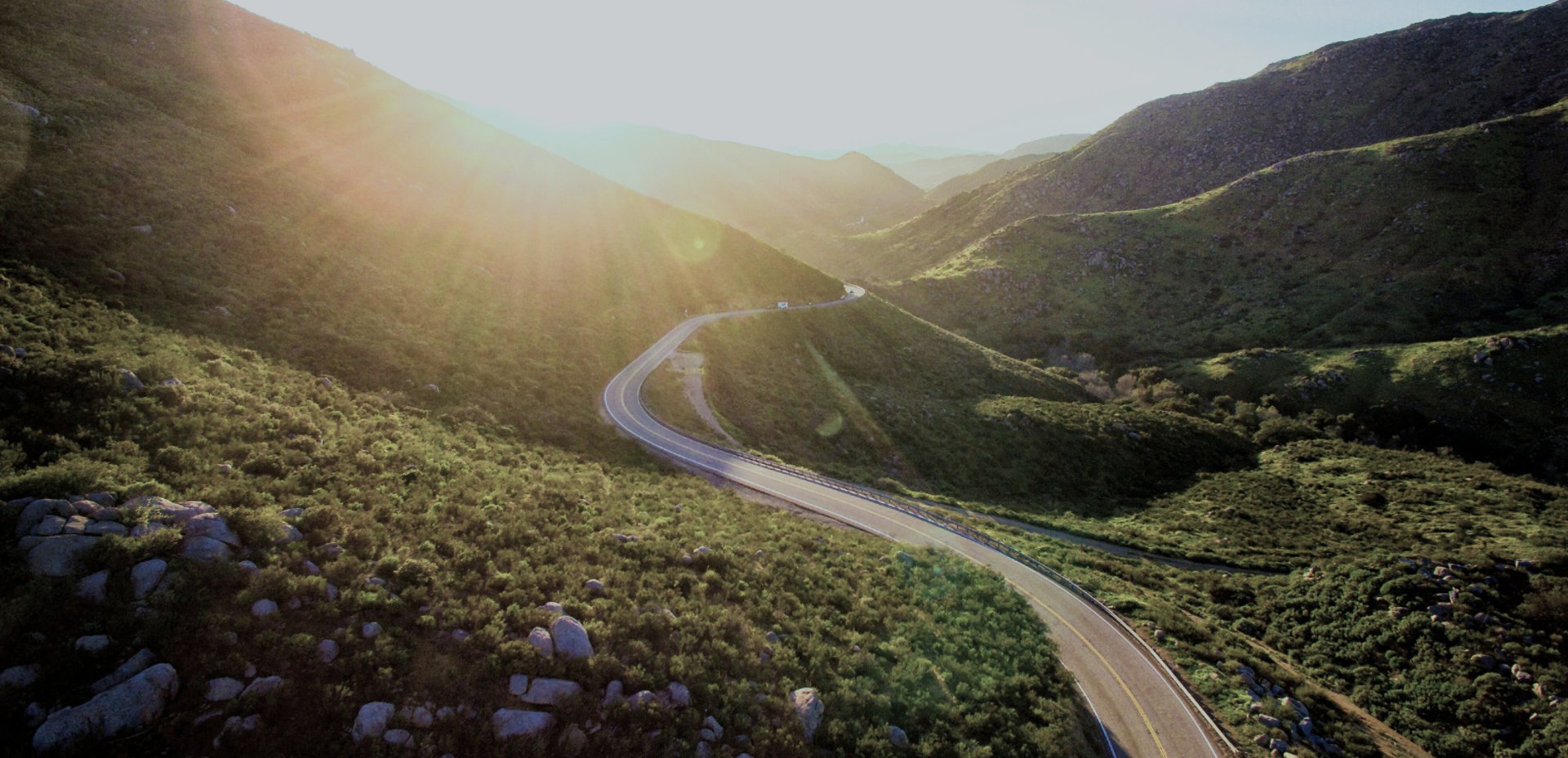 an abstract photo of a curved building with a blue sky in the background