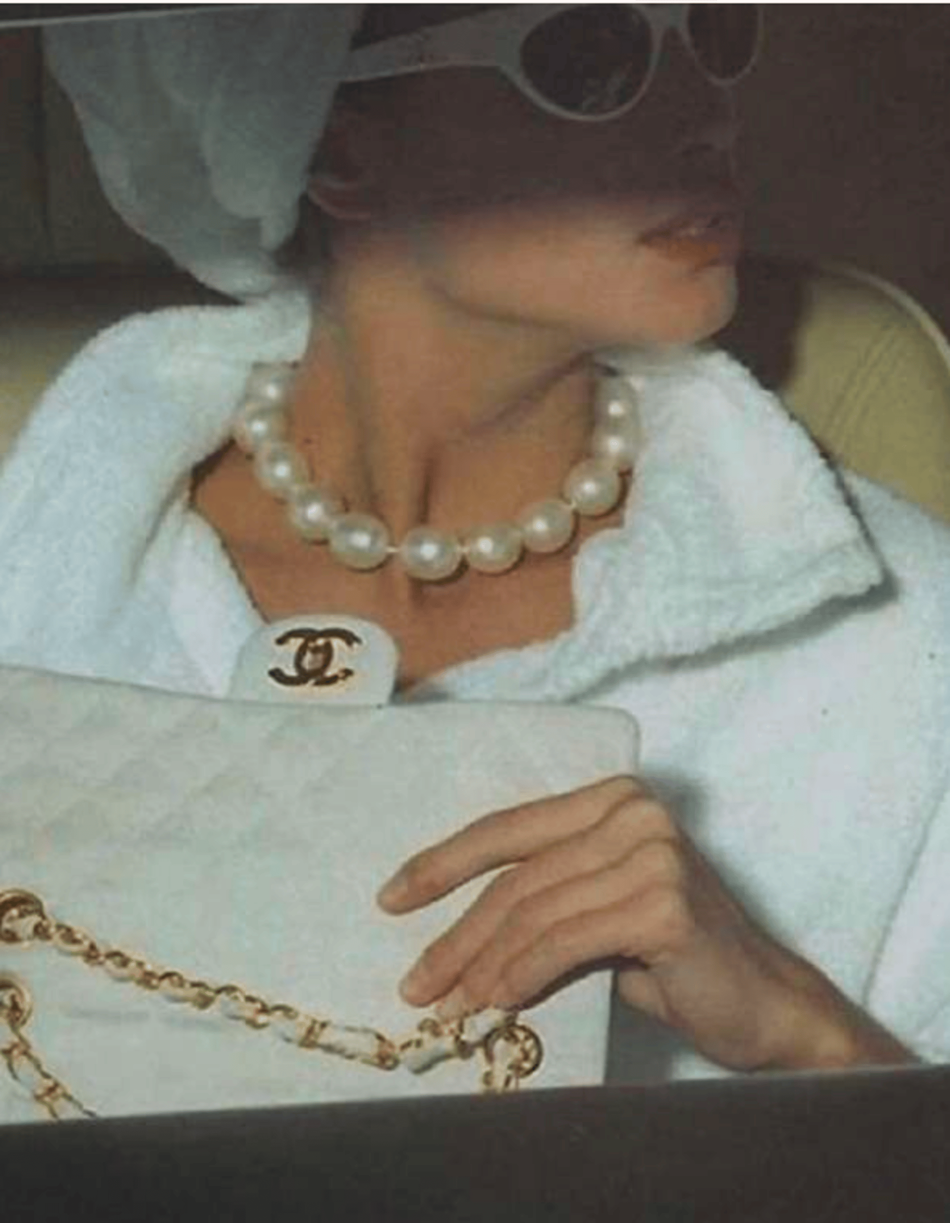 a black mannequin with a gold necklace on it