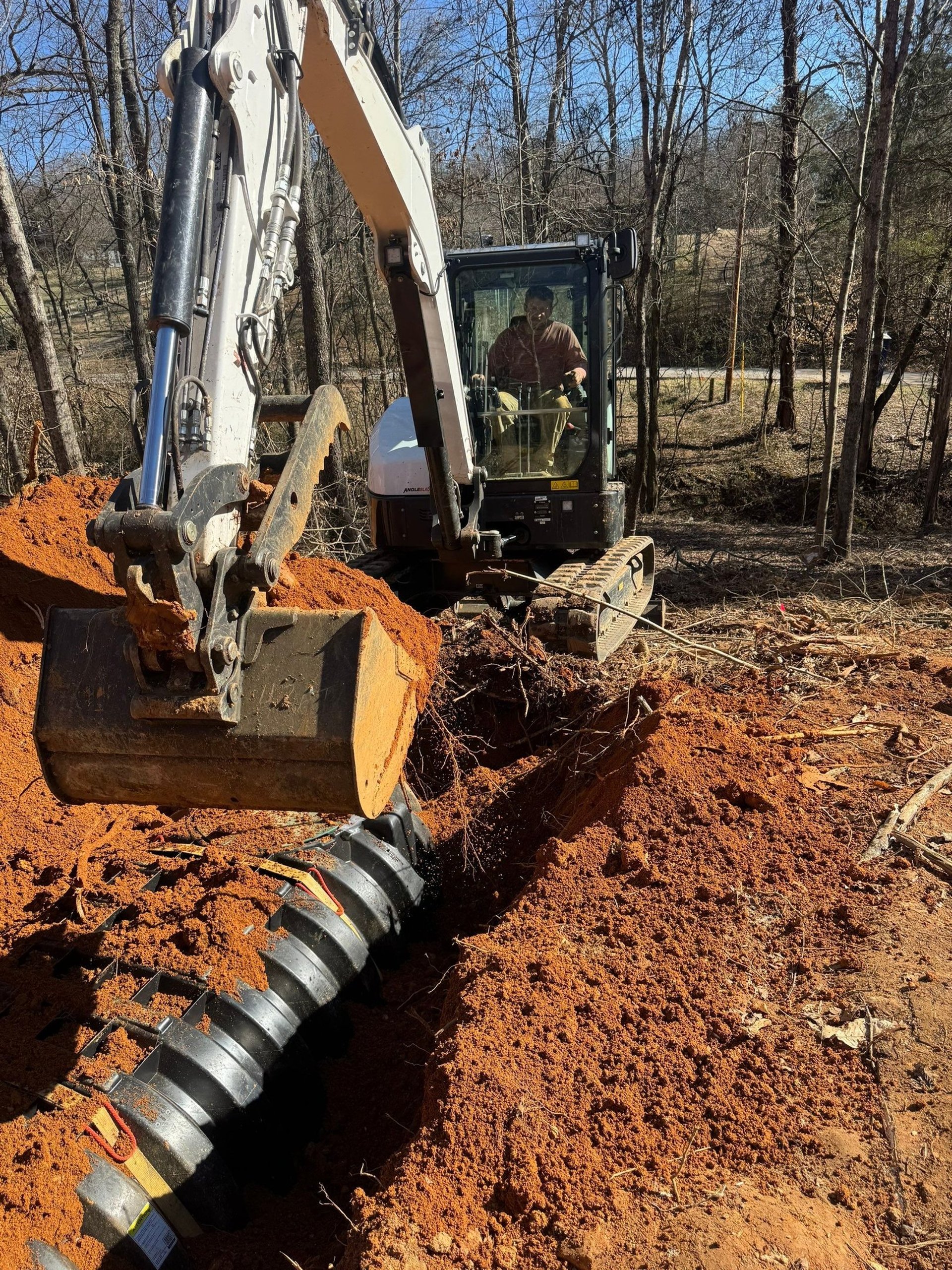 Bobcat E60 excavator backfilling a septic system in Lake-A-Wana TN