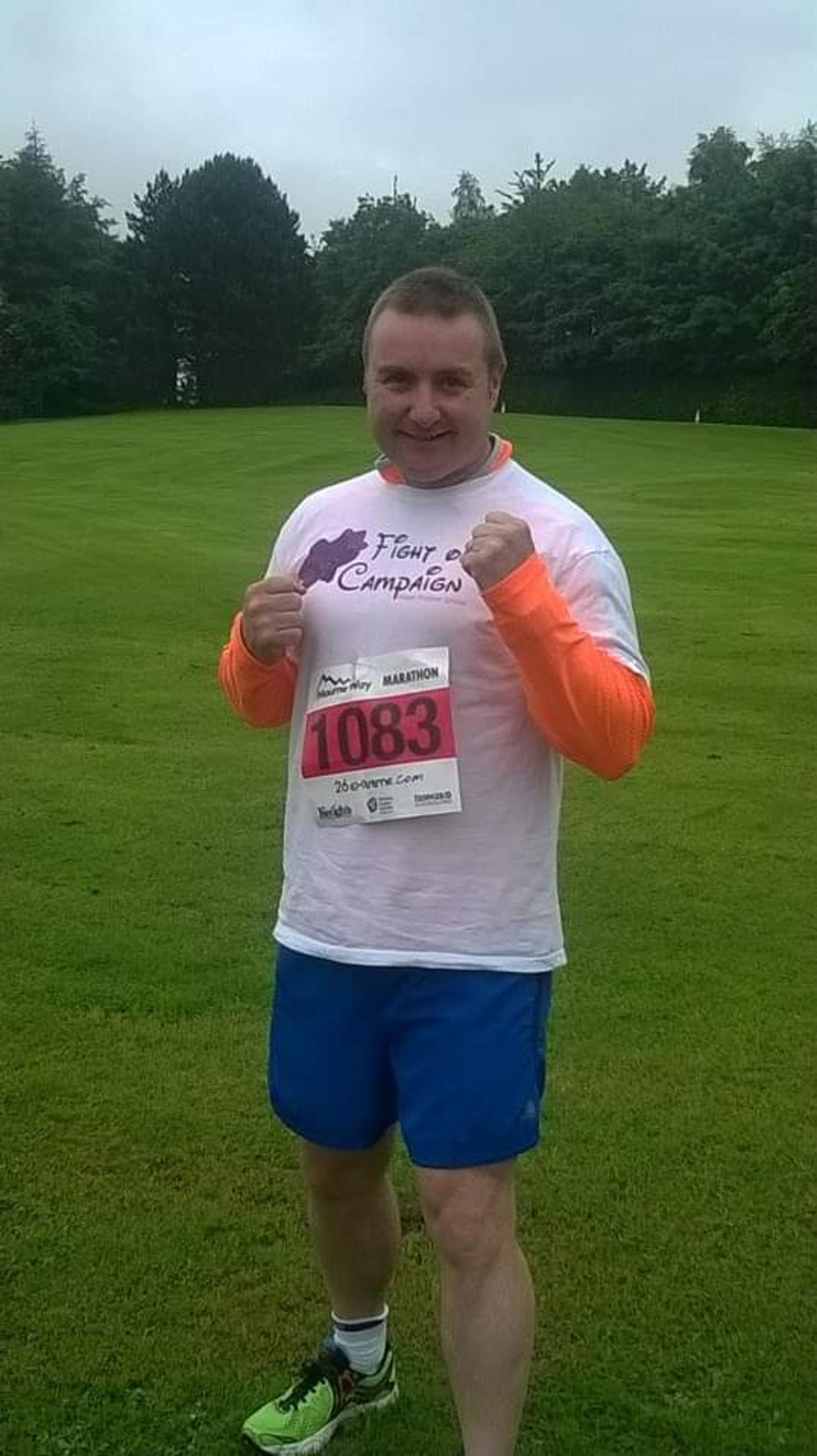 man standing on mountain beside trees