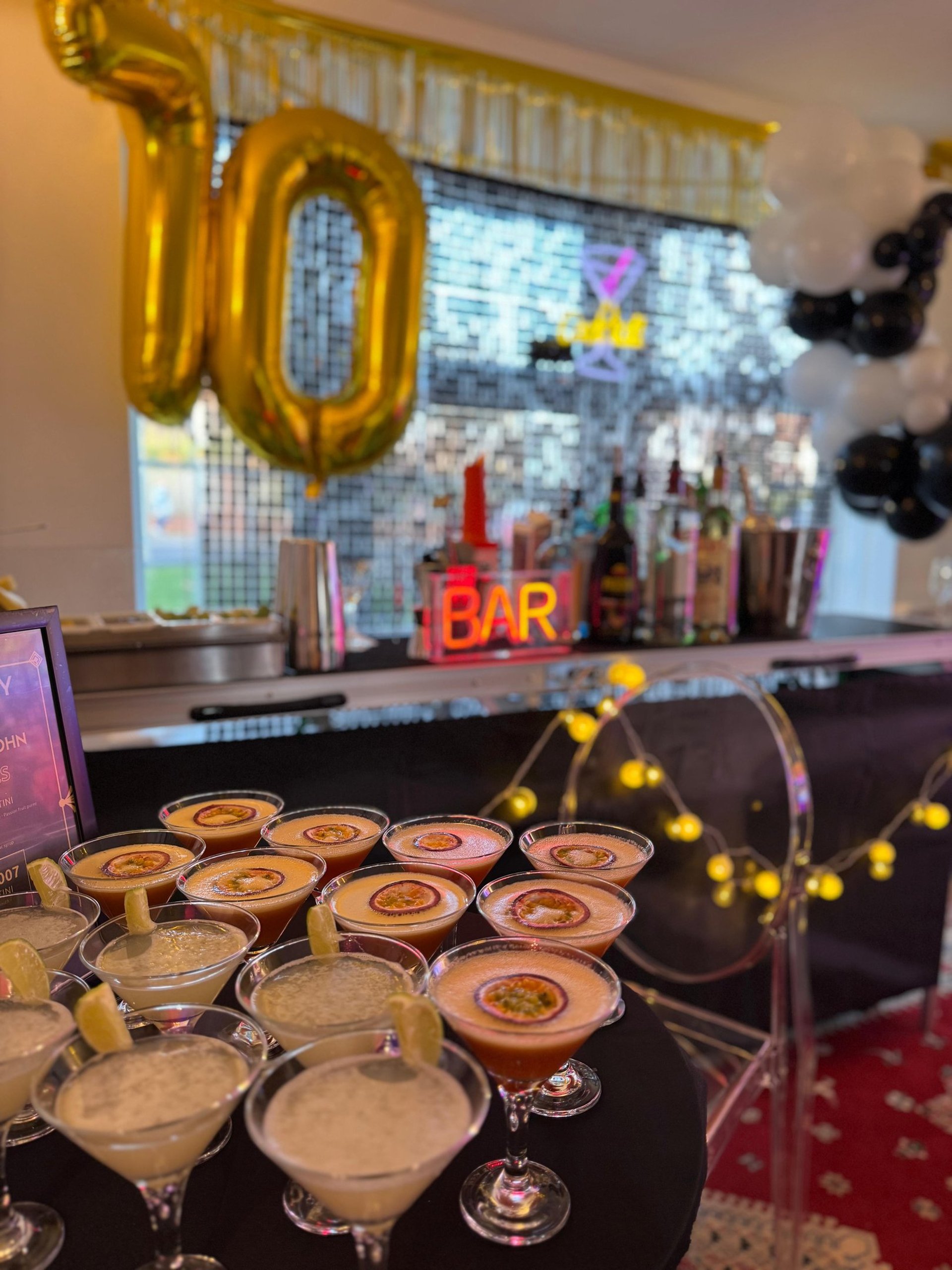 man in black suit jacket holding clear wine glass