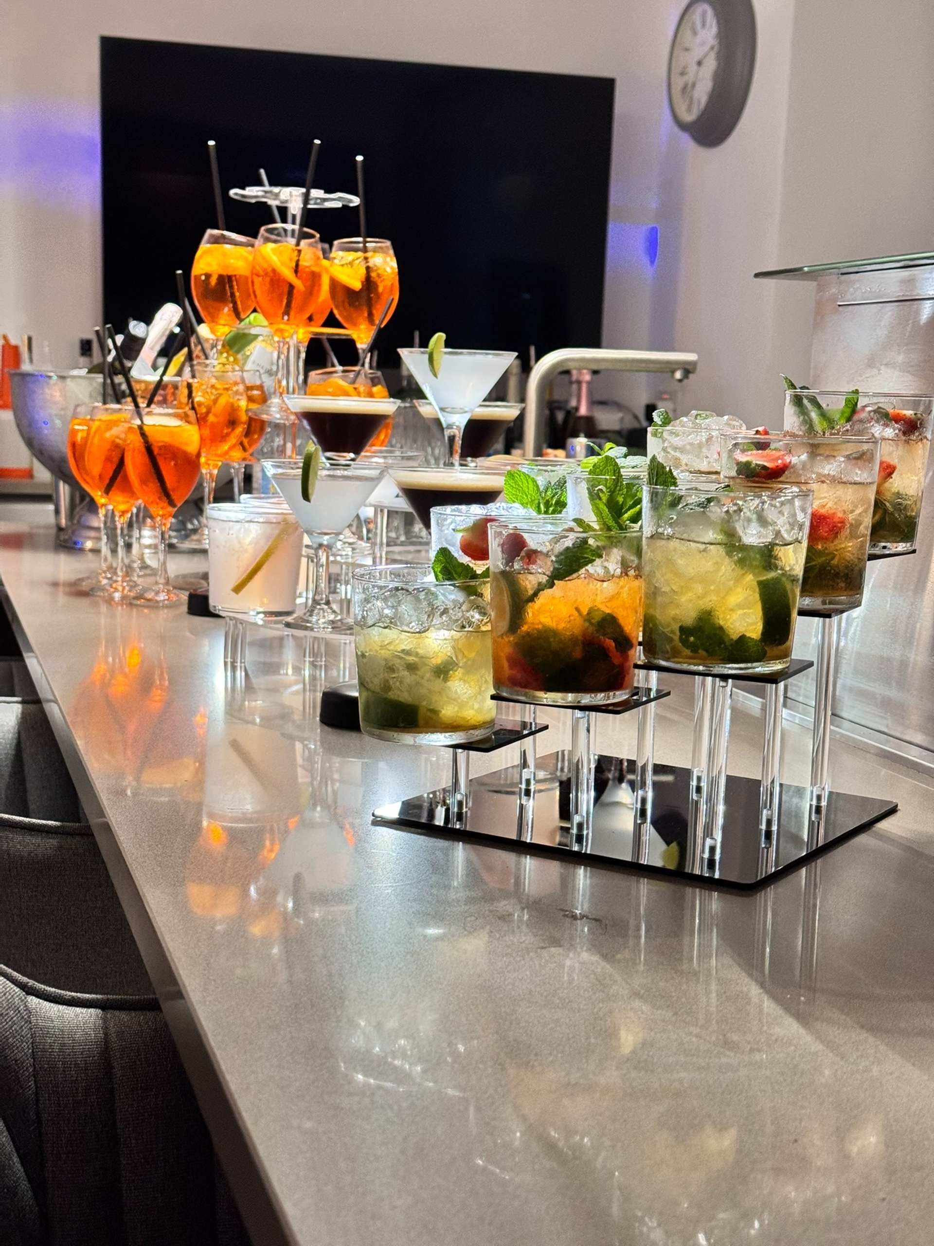woman holding clear glass cup with blue liquid