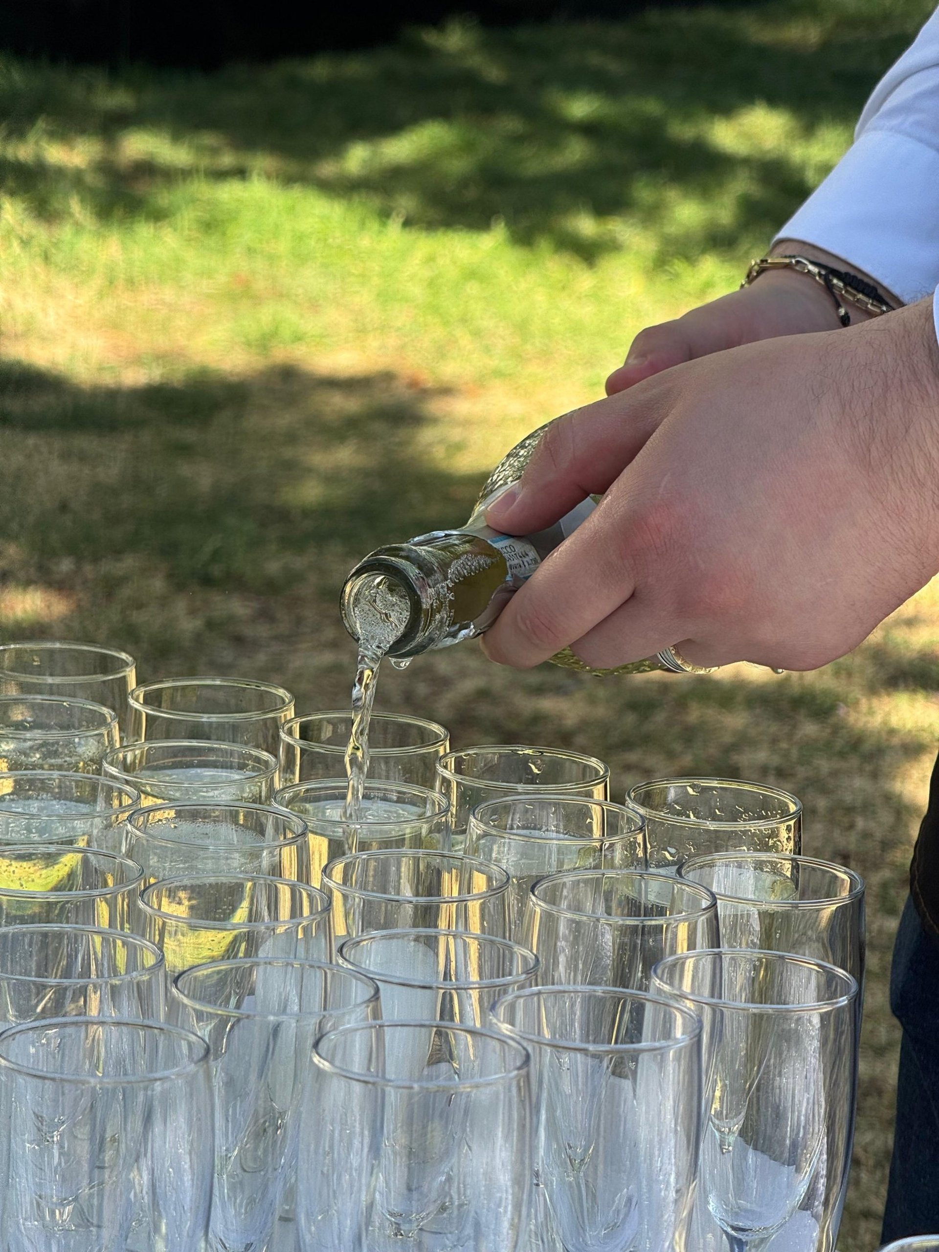 group of people holding footed glasses