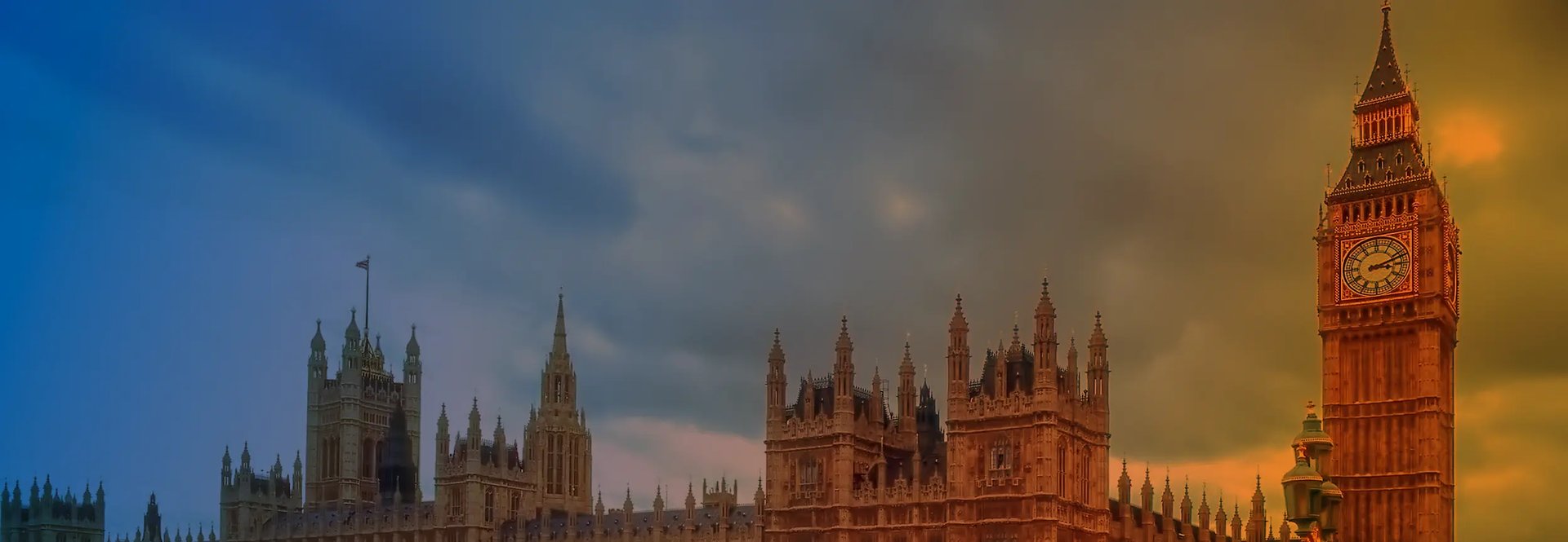 red double-decker bus passing Palace of Westminster, London during daytime