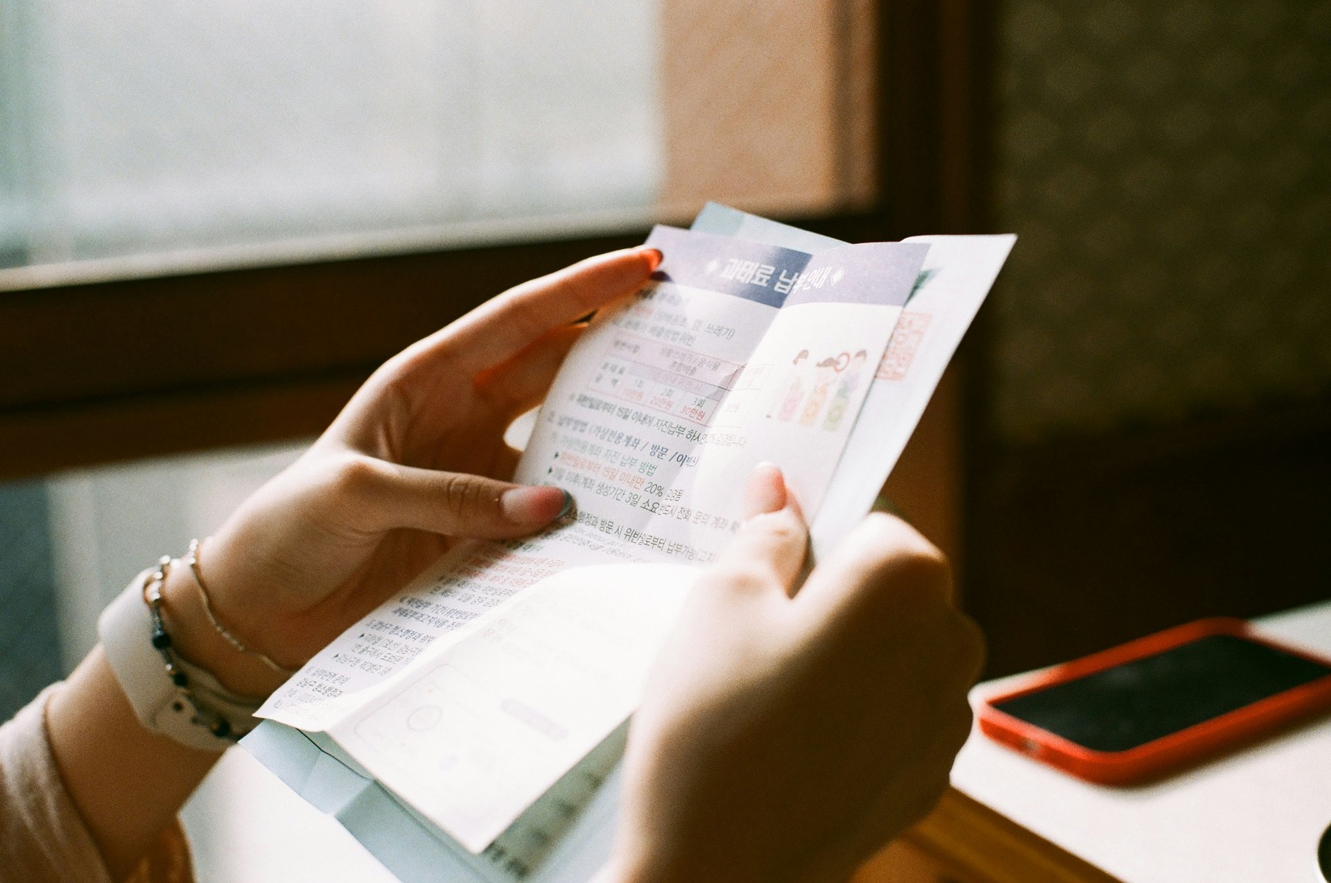 Woman is holding a bill on her hands
