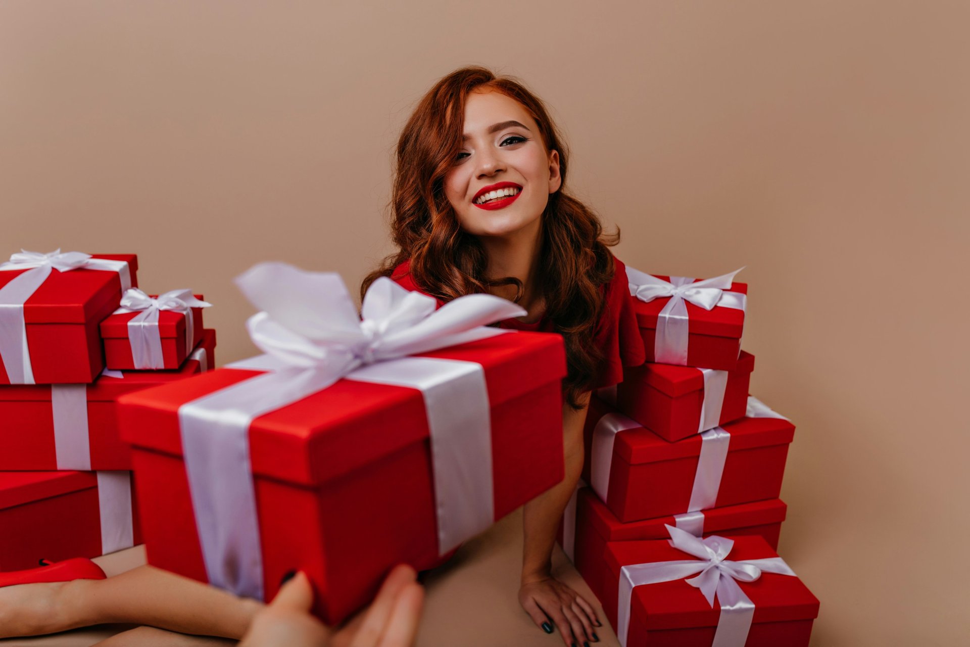 Lady is sitting and recieving gifts