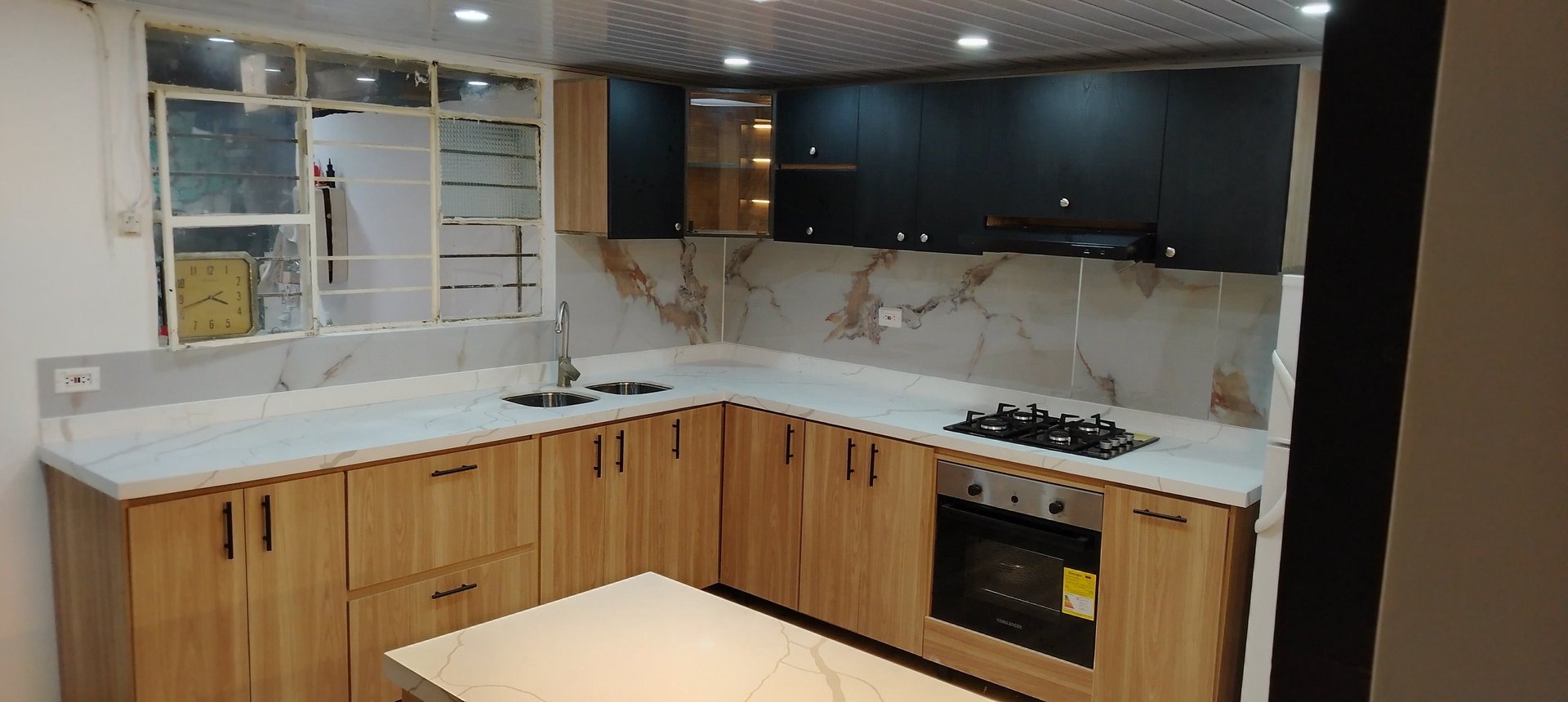a large kitchen with a marble counter top