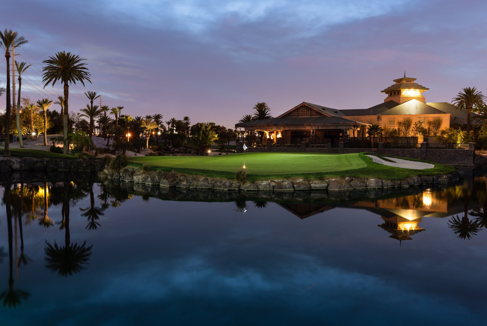 man in black shirt and pants standing on green grass field under white clouds and blue