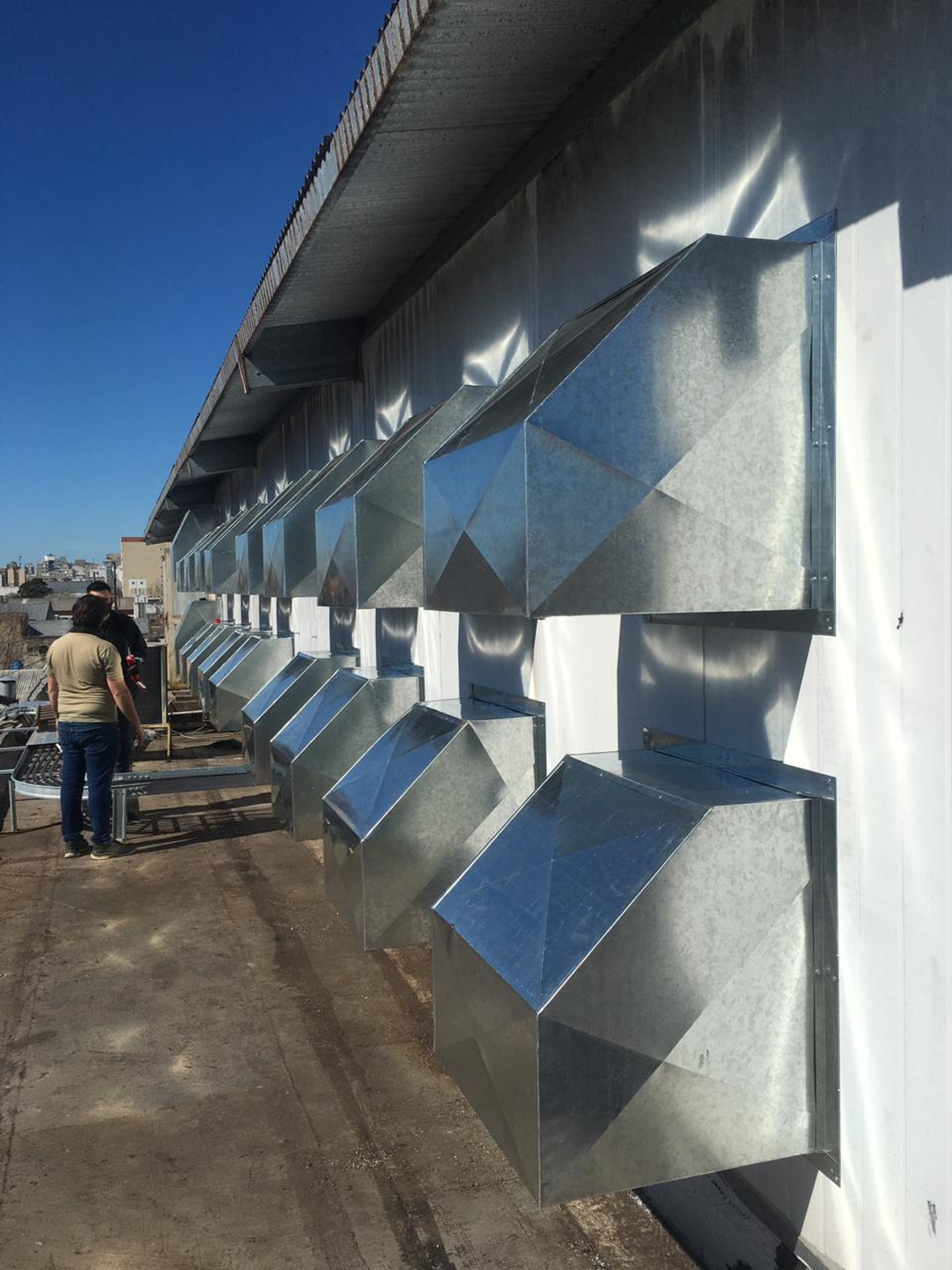 an abstract photo of a curved building with a blue sky in the background