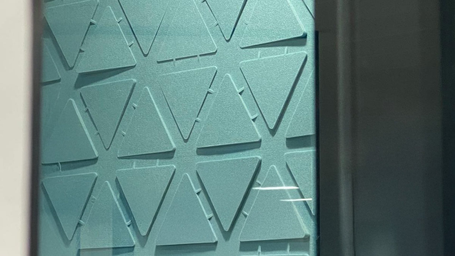 an abstract photo of a curved building with a blue sky in the background