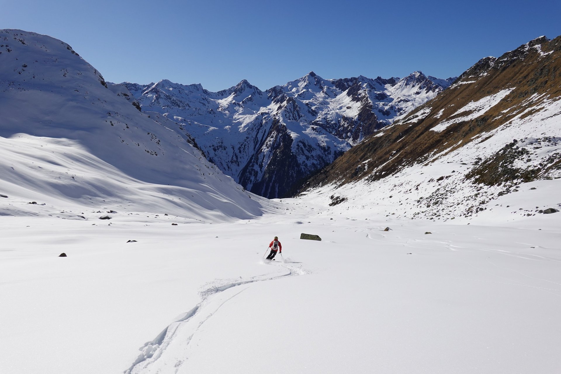 an abstract photo of a curved building with a blue sky in the background