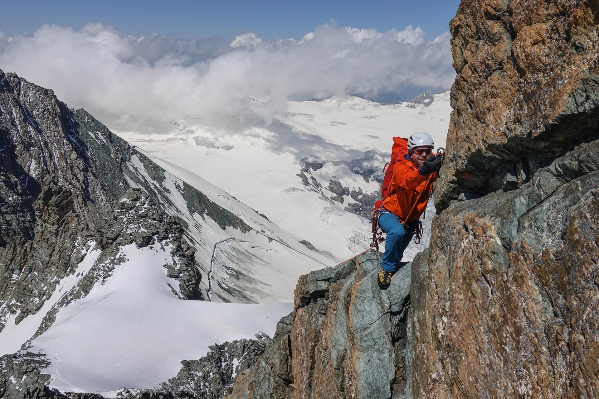 an abstract photo of a curved building with a blue sky in the background