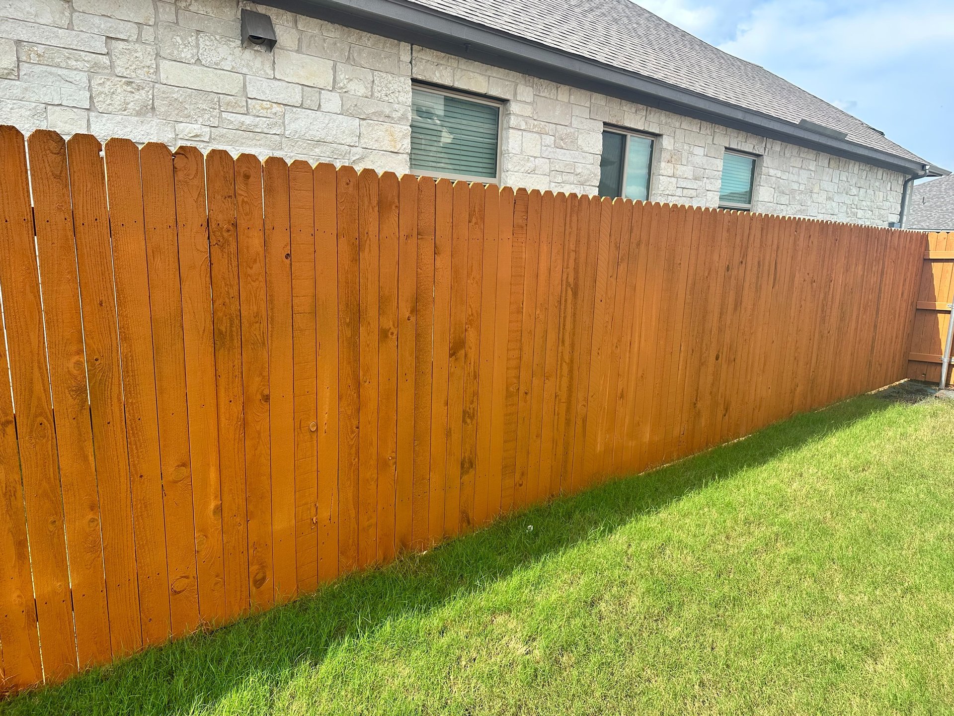 a deck with chairs and tables on it and a deck with plants