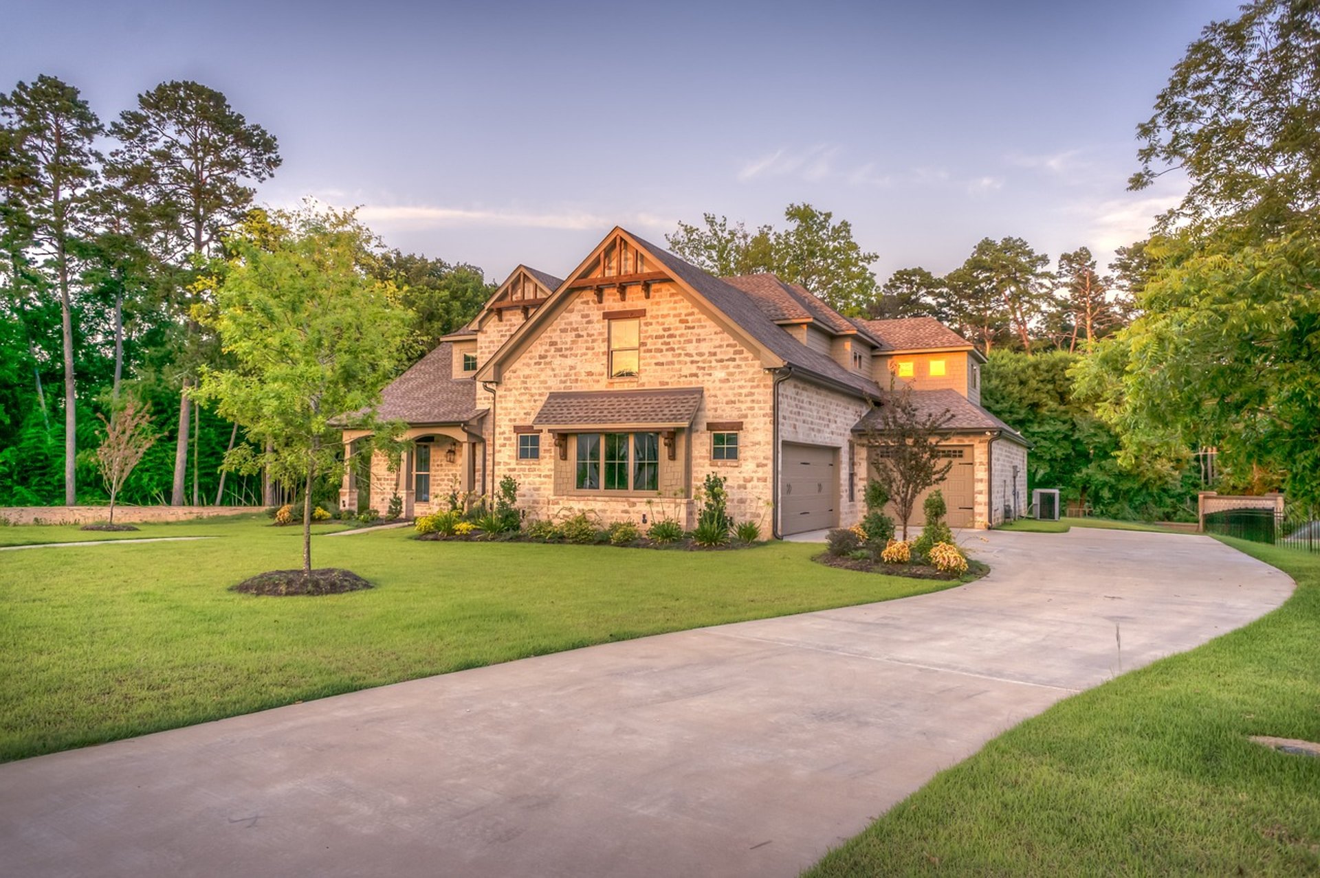 a neat house with clean driveway and landscape