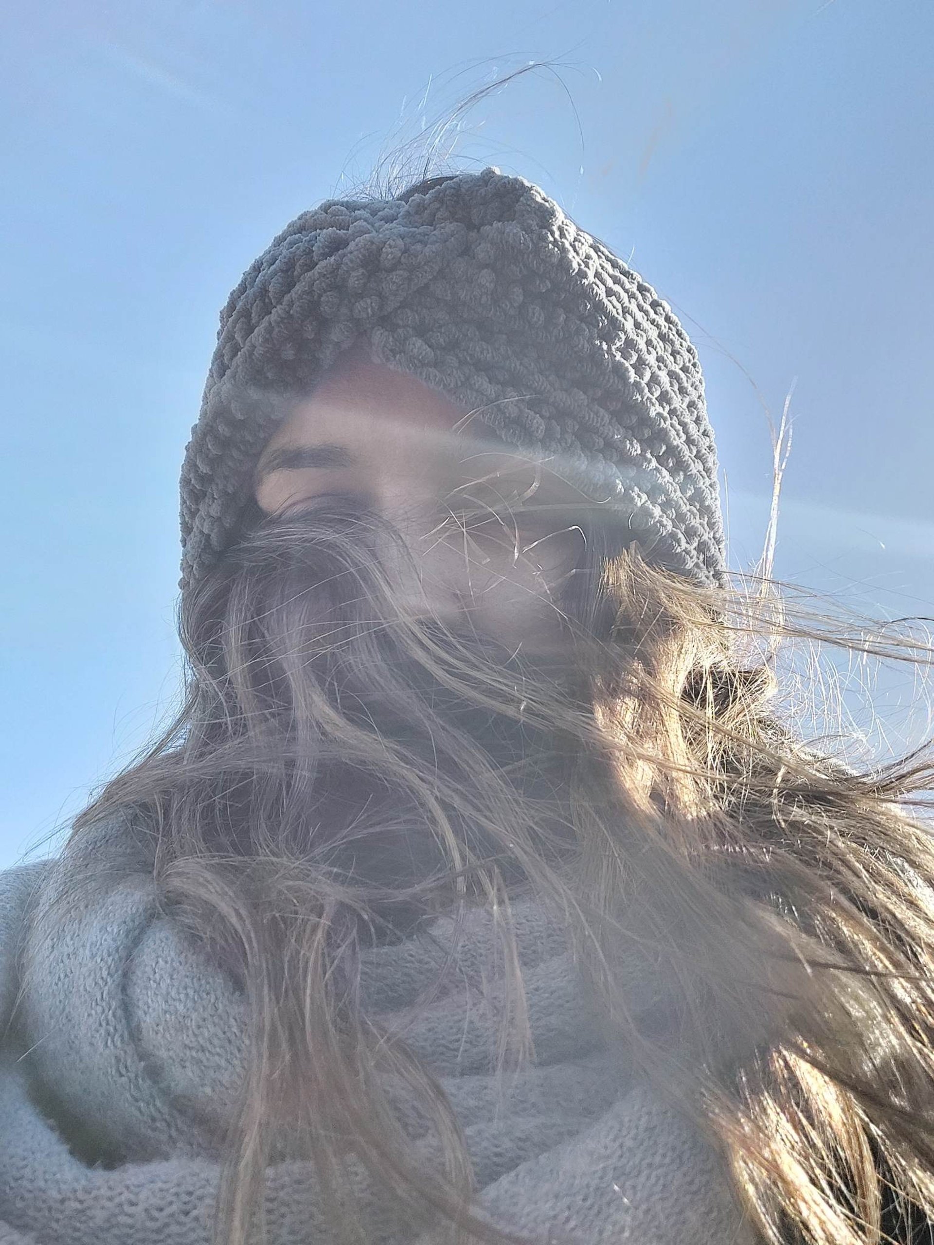 an abstract photo of a curved building with a blue sky in the background