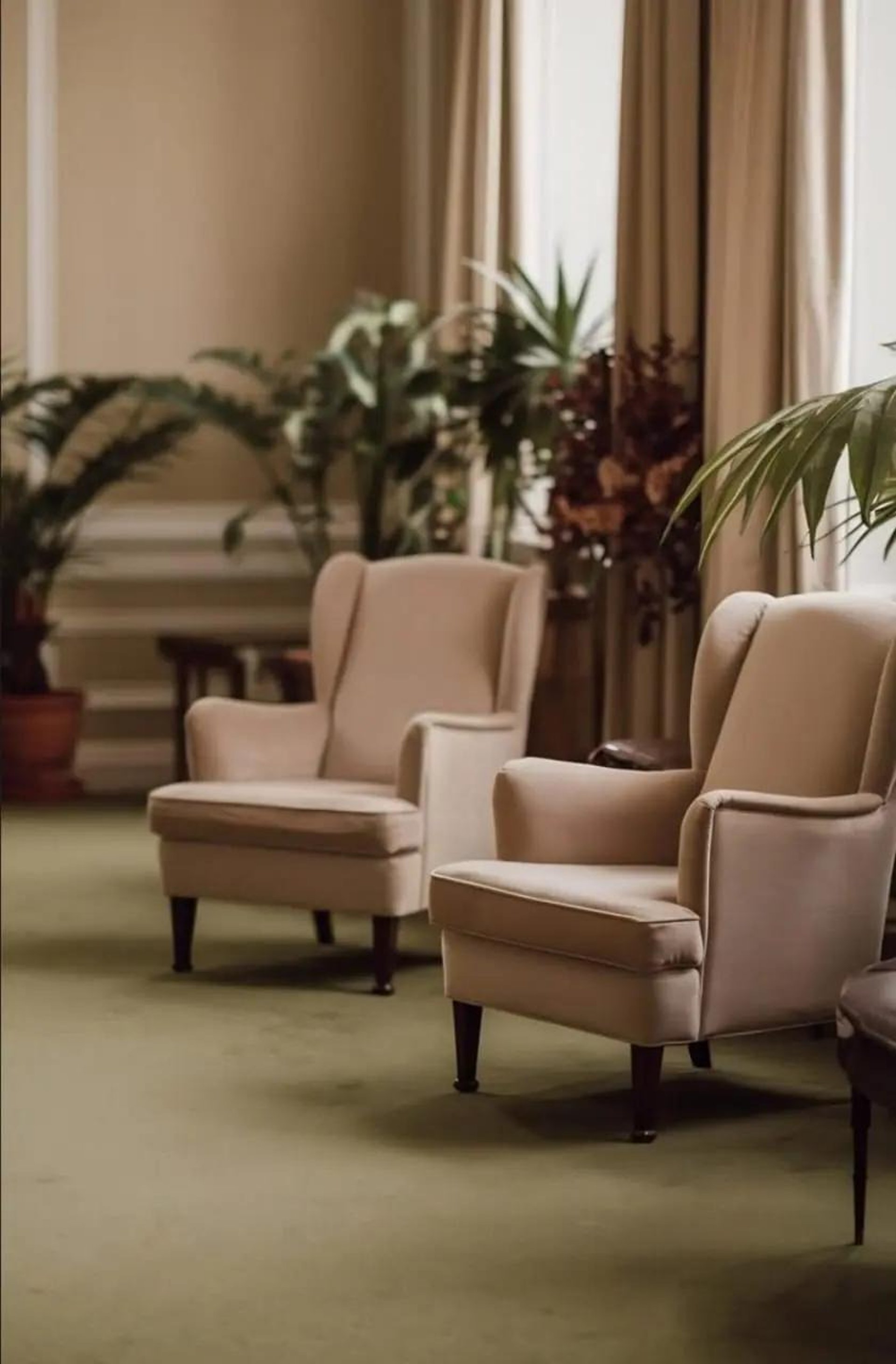 a living room filled with furniture and a mirror