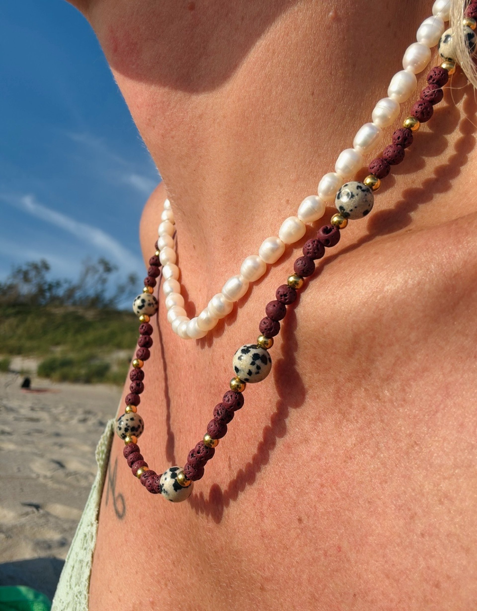 silver diamond ring on pink textile