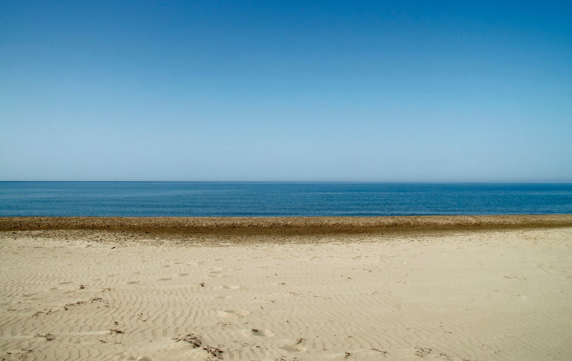 an abstract photo of a curved building with a blue sky in the background