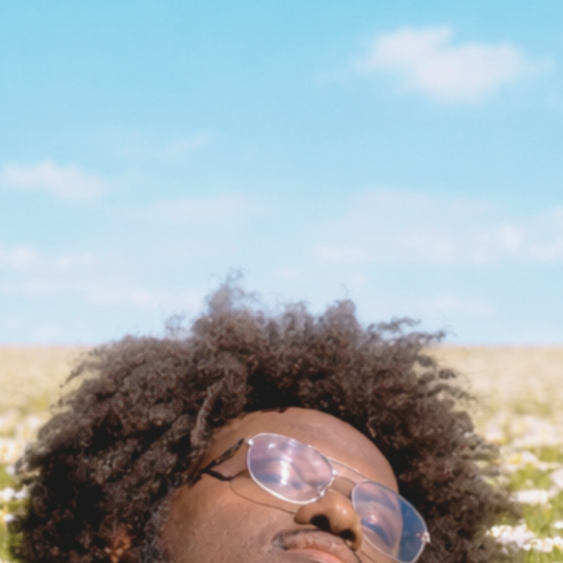 an abstract photo of a curved building with a blue sky in the background