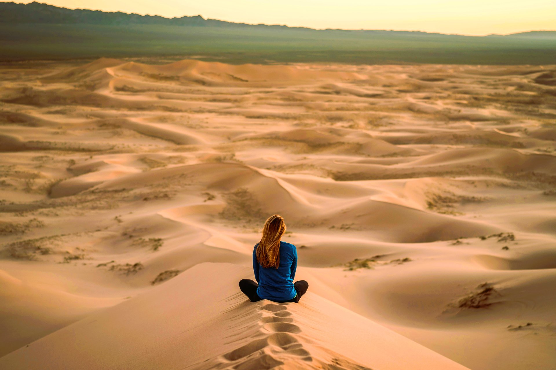 woman sitting on bench over viewing mountain