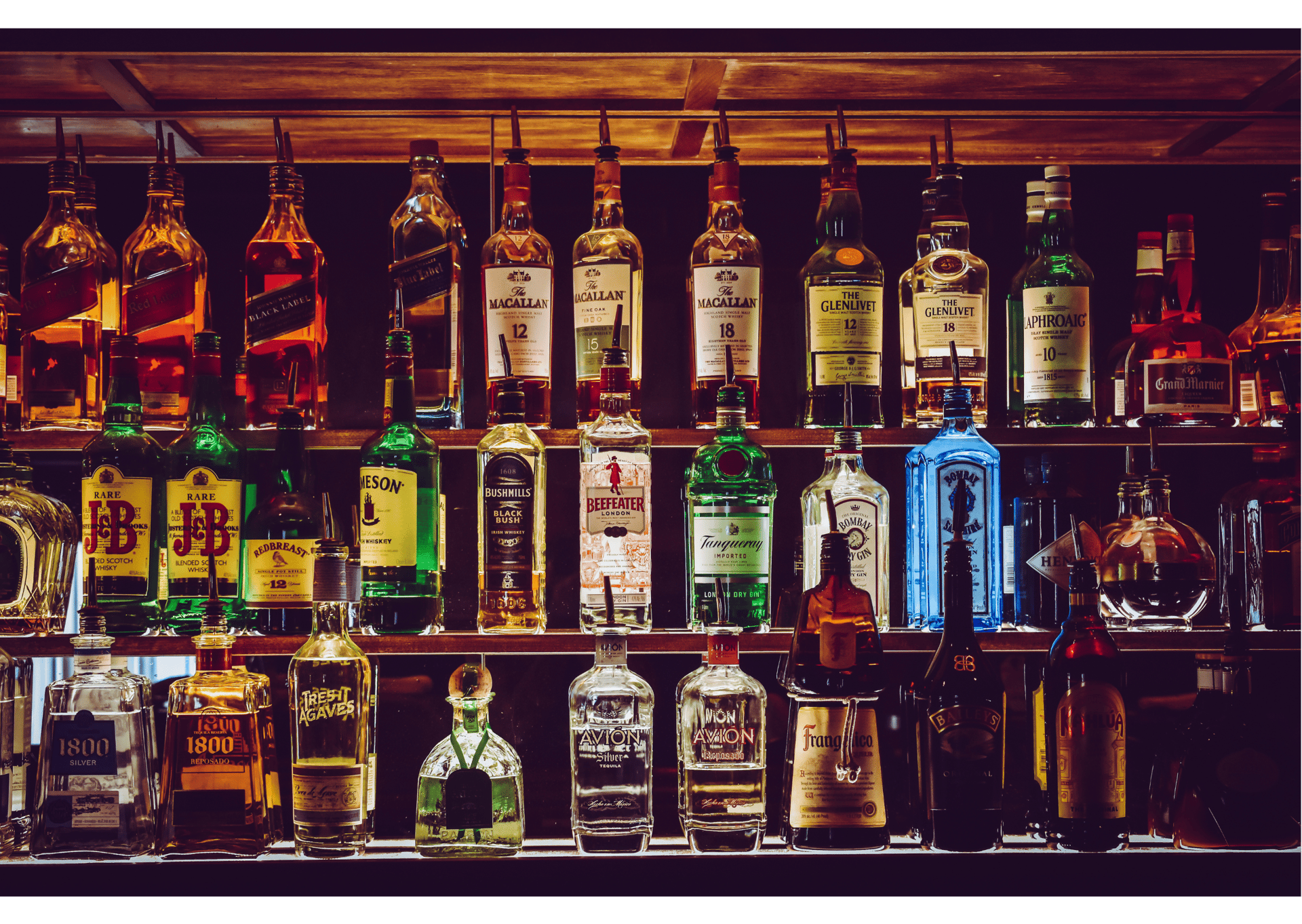 a shelf filled with lots of bottles of liquor