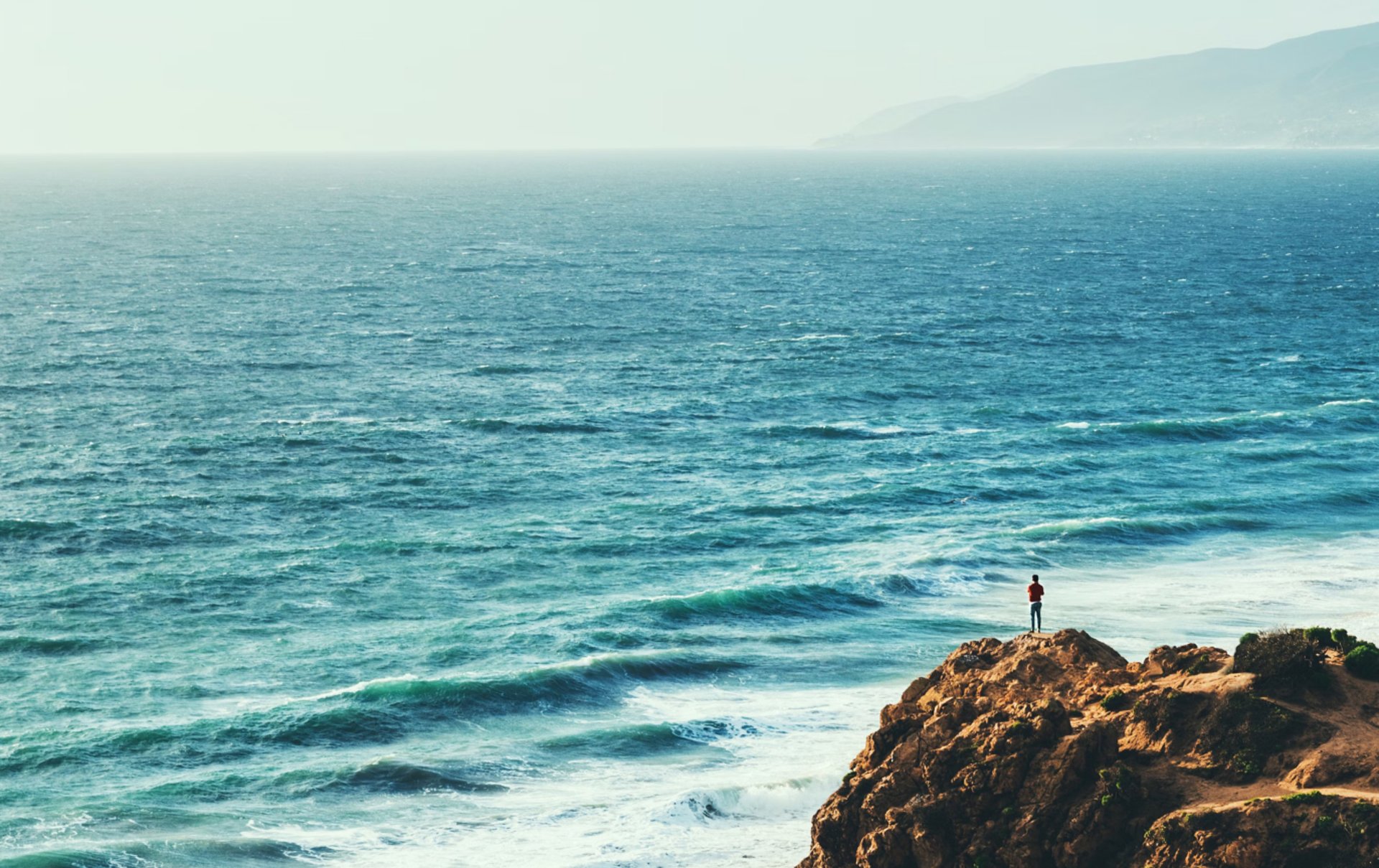 man standing on cliff