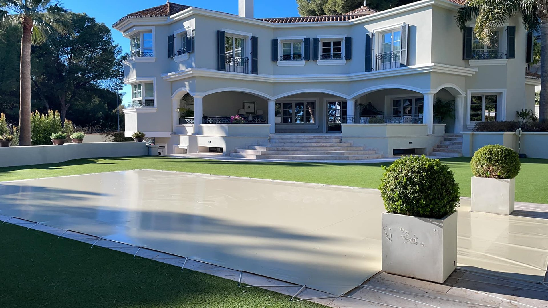 an abstract photo of a curved building with a blue sky in the background