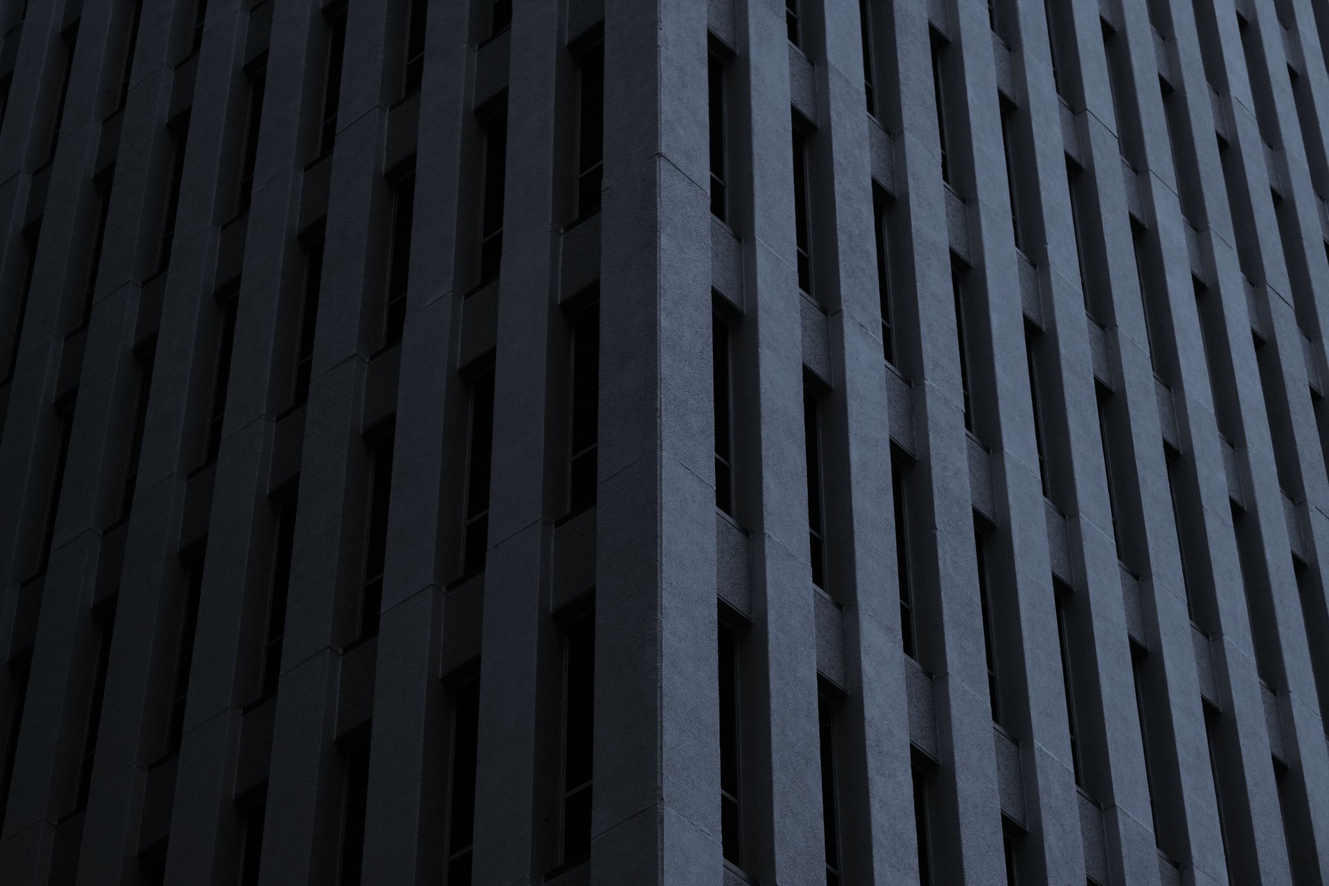 an abstract photo of a curved building with a blue sky in the background