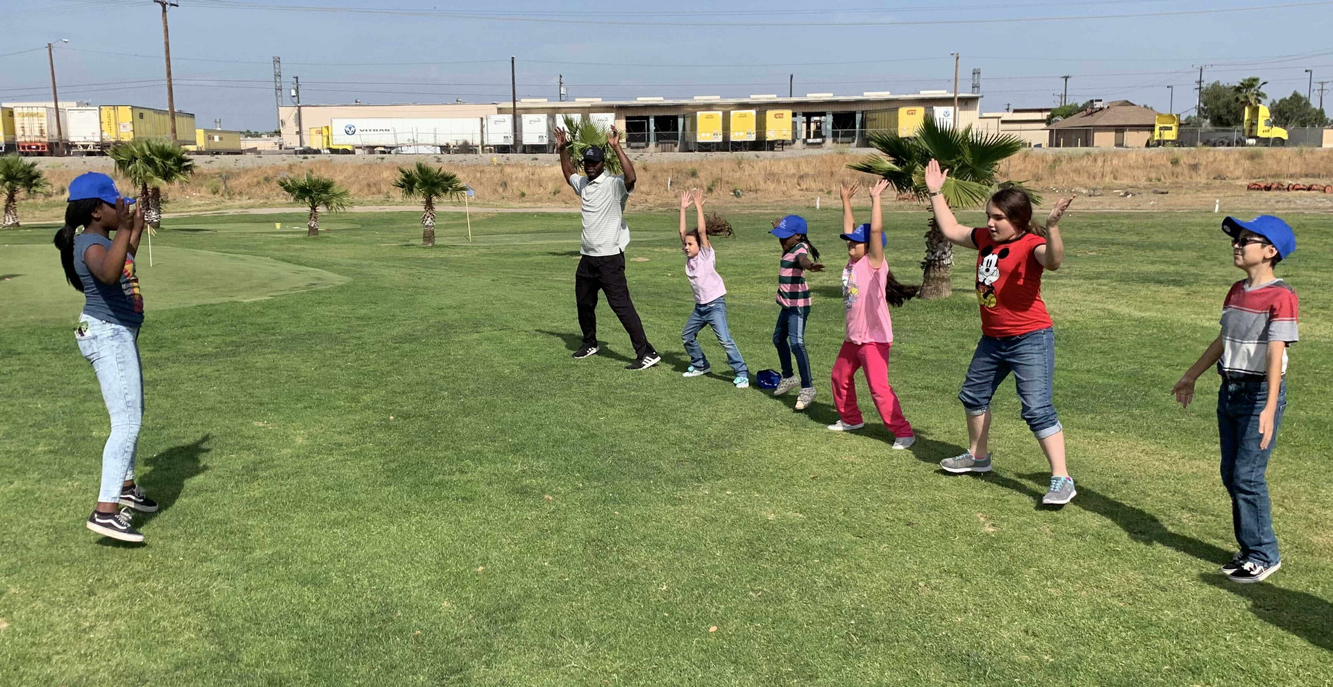 Enhancing Forward Action Inc. image of children golfers exercising