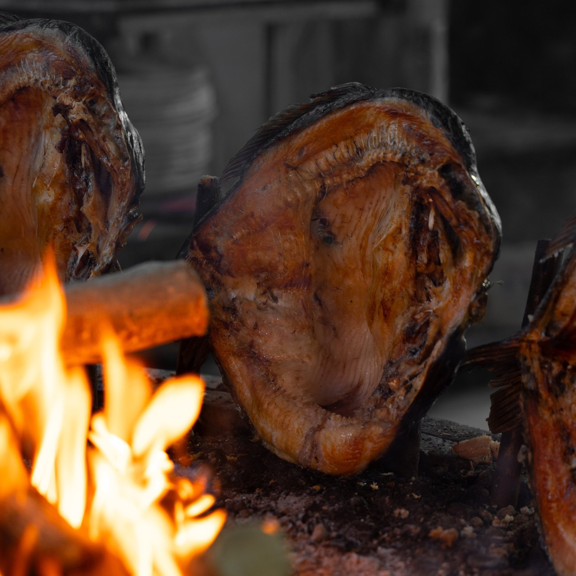 a blue bowl filled with vegetables and a wooden spoon