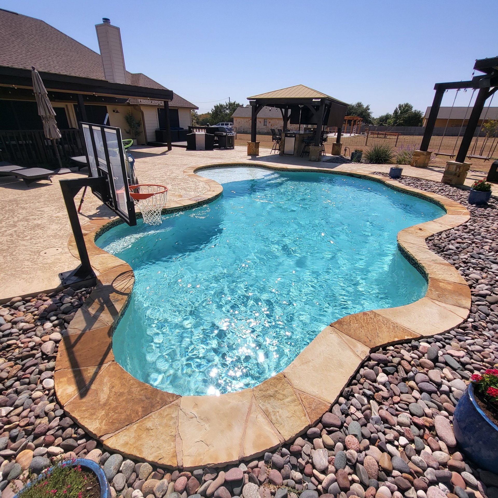 pristine blue swimming pool showing excellence in pool cleaning services, results, and satisfied customers