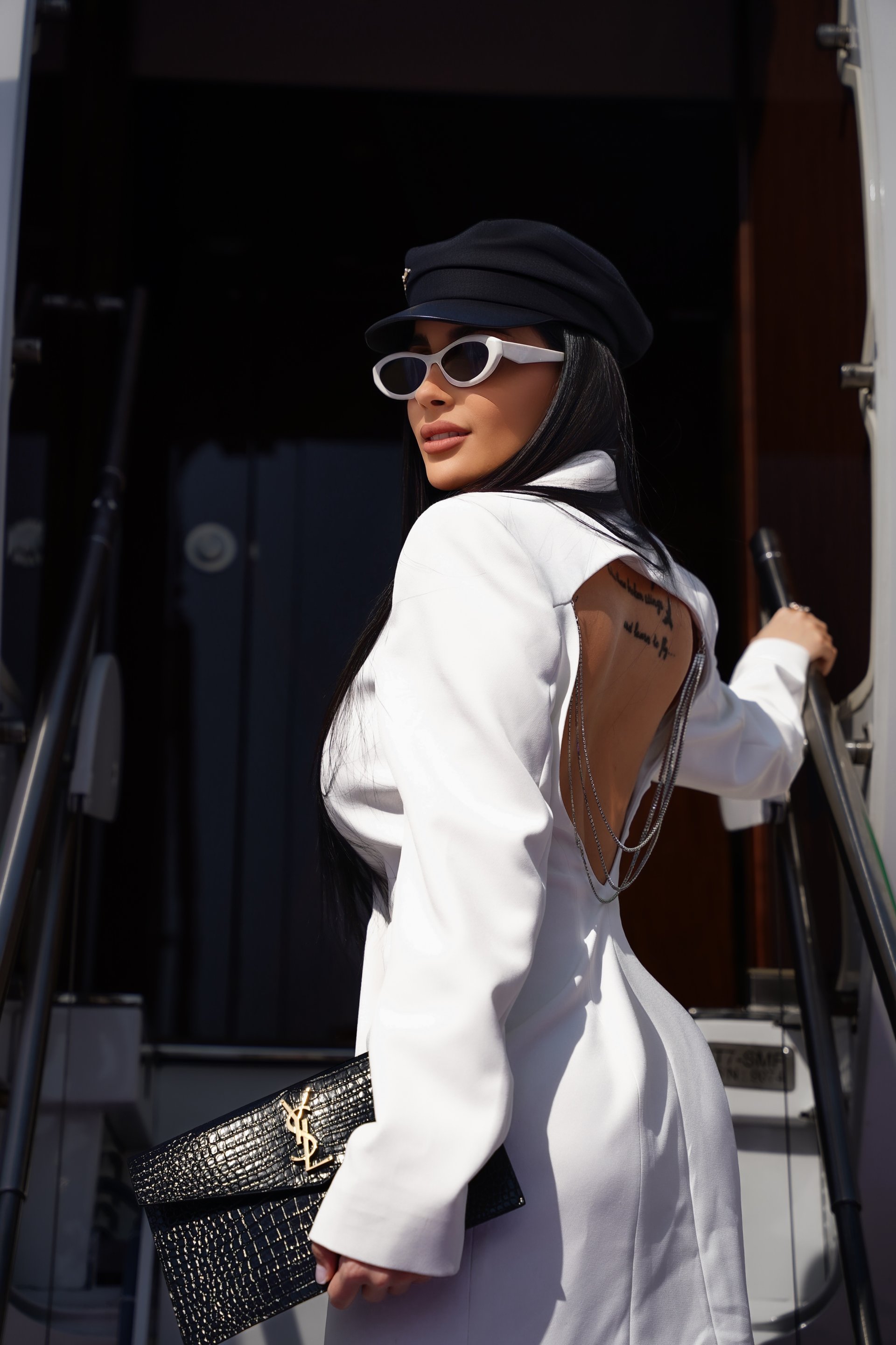 an abstract photo of a curved building with a blue sky in the background