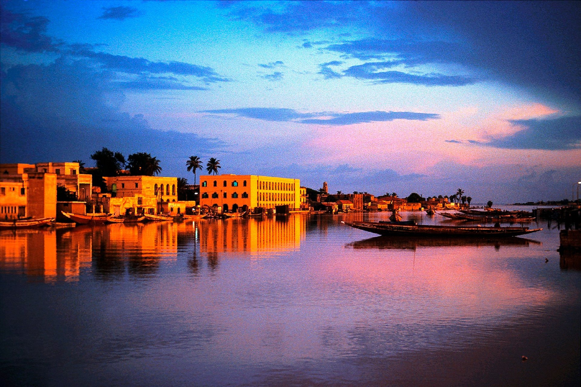 an abstract photo of a curved building with a blue sky in the background