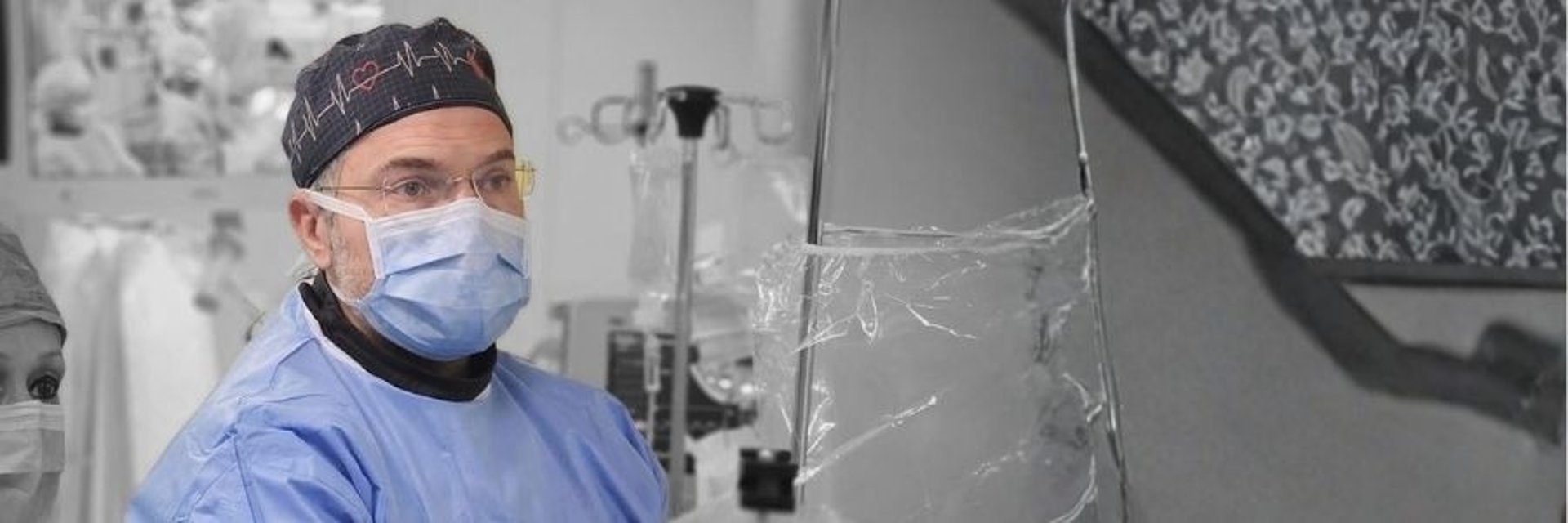 Surgeons performing a medical procedure in an operating room.