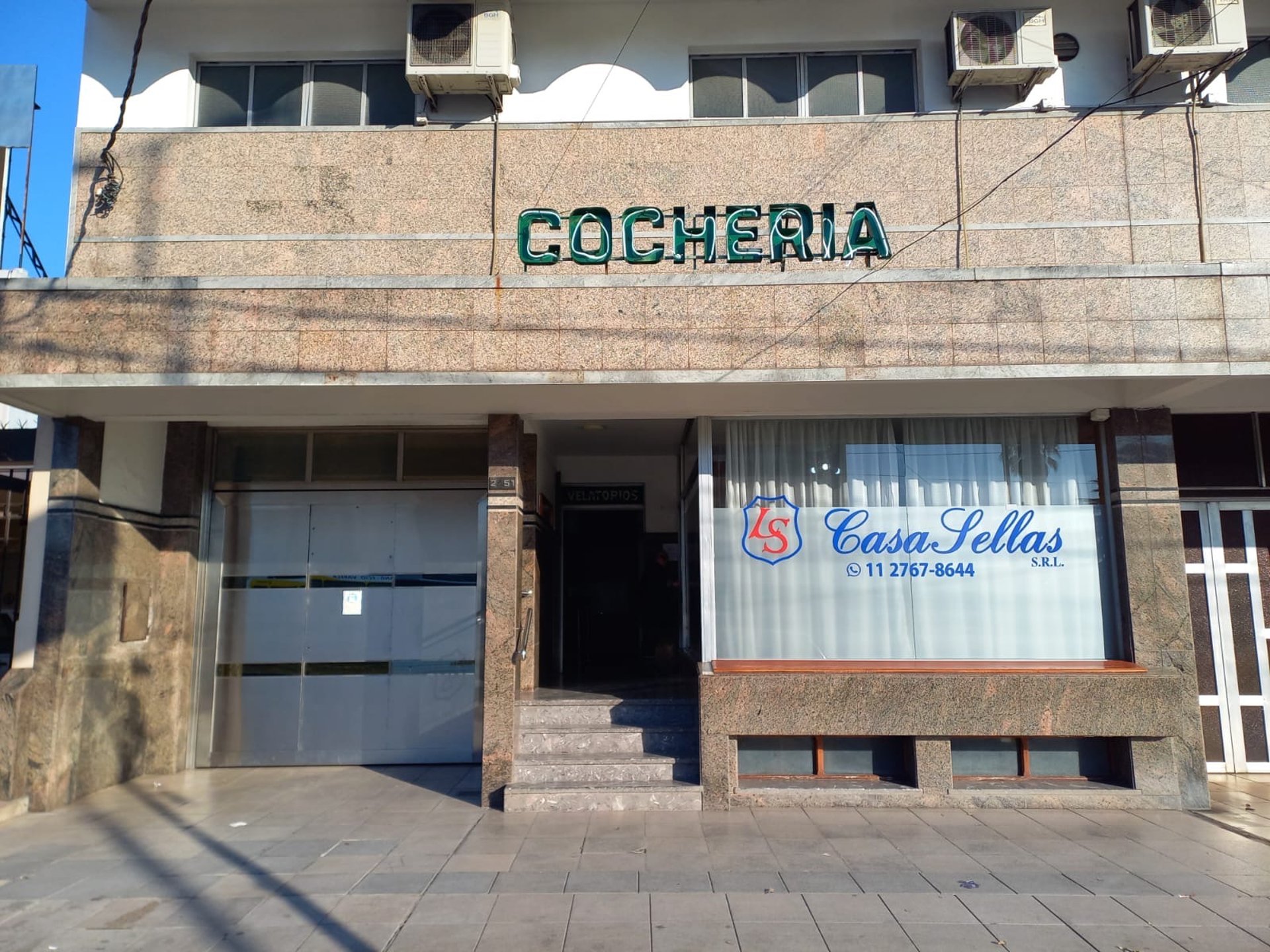 an abstract photo of a curved building with a blue sky in the background