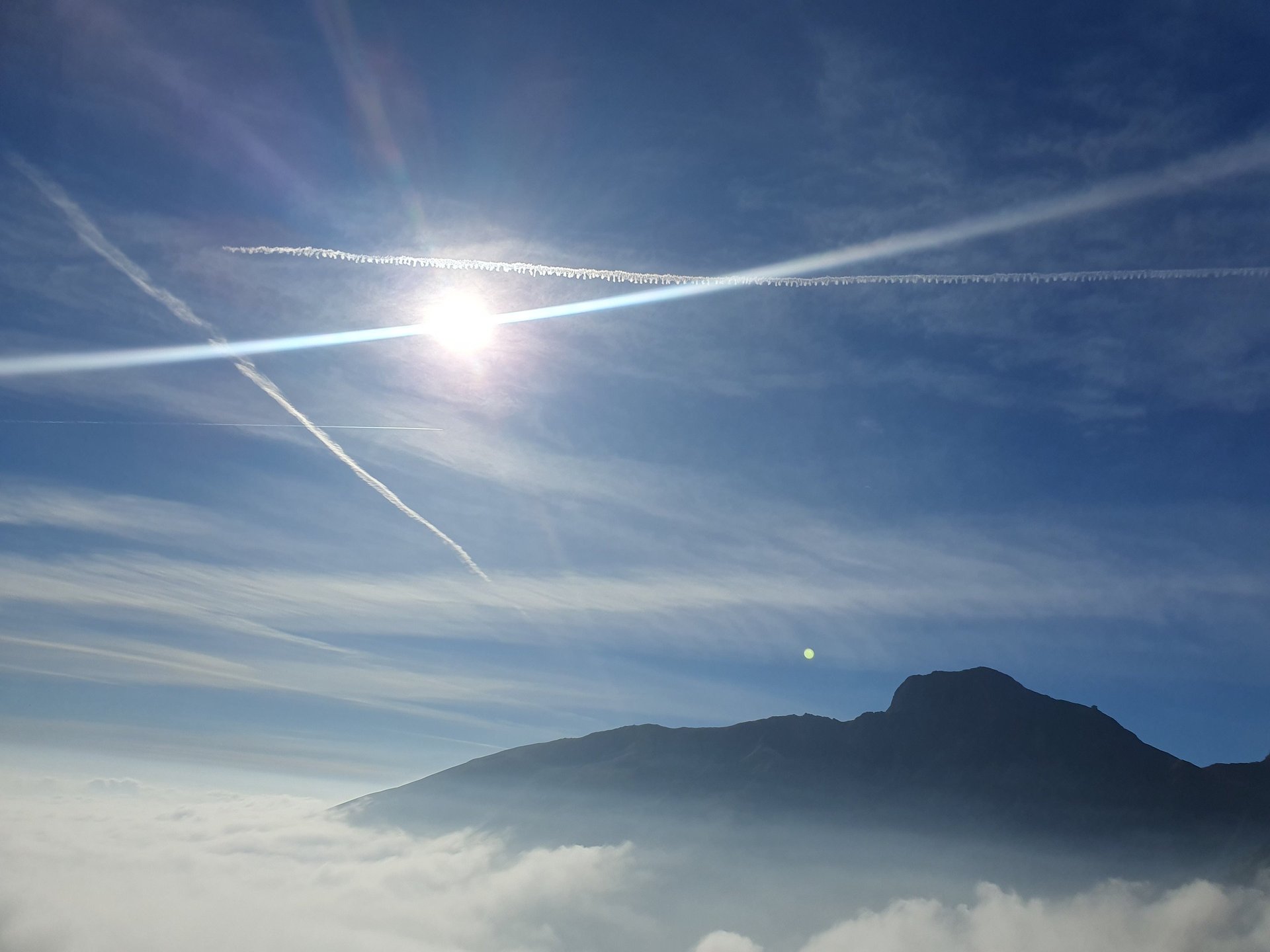 woman wearing yellow long-sleeved dress under white clouds and blue sky during daytime